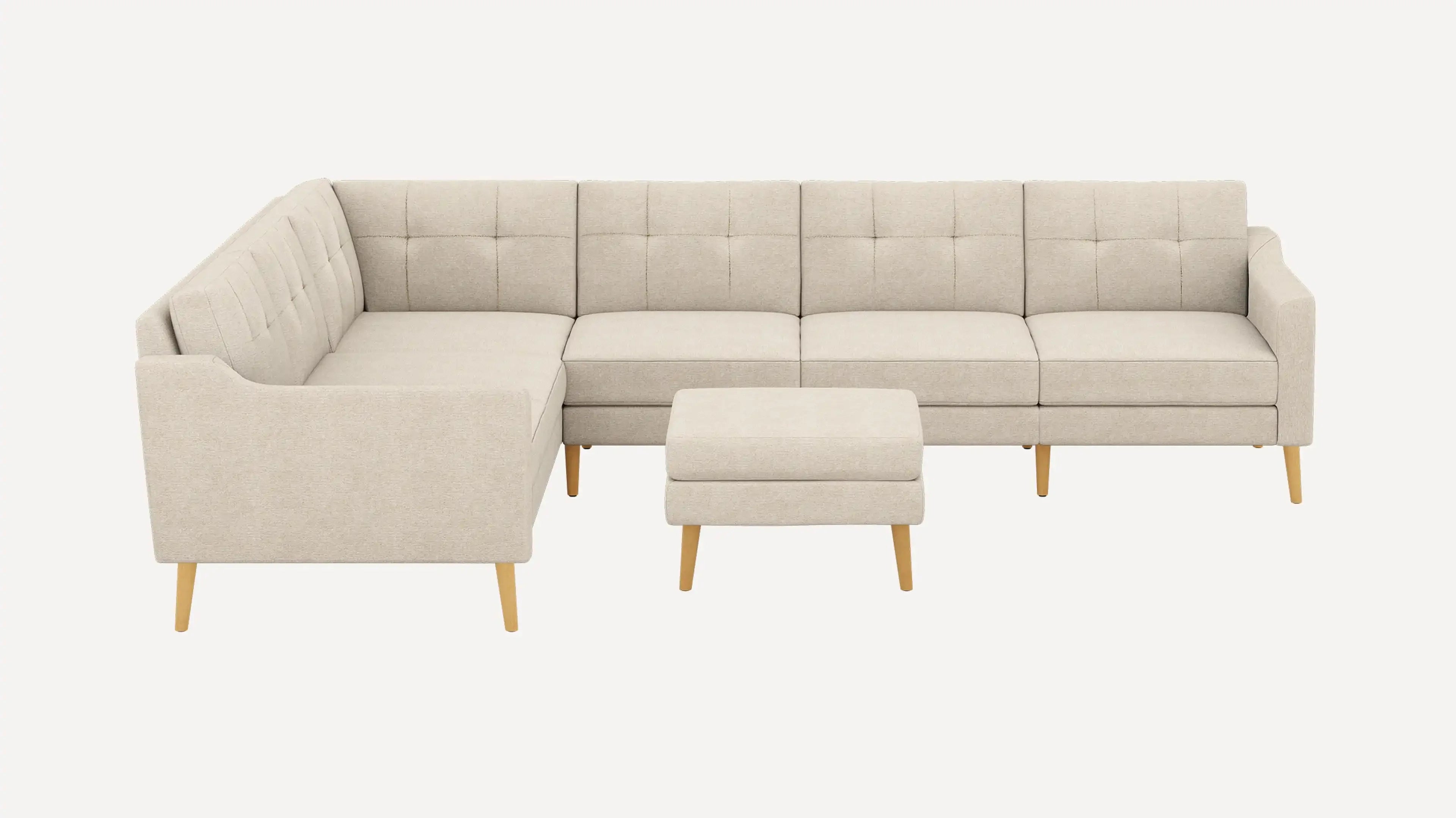 modern beige fabric sectional sofa with tufted back cushions and wooden legs, featuring a matching ottoman and matching ottoman