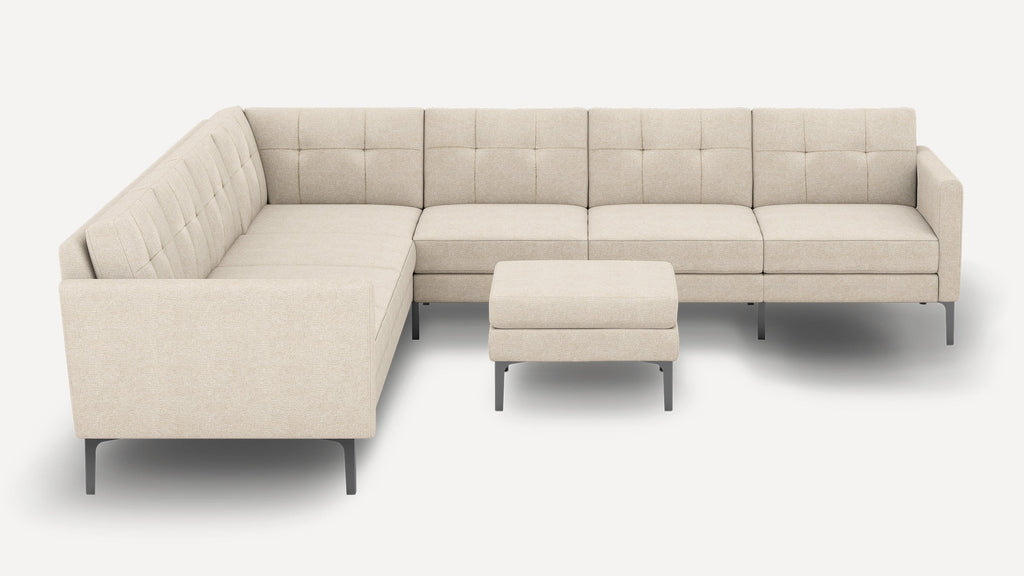 Modern L-shaped beige sectional sofa with tufted cushions and metal legs, accompanied by a matching ottoman.