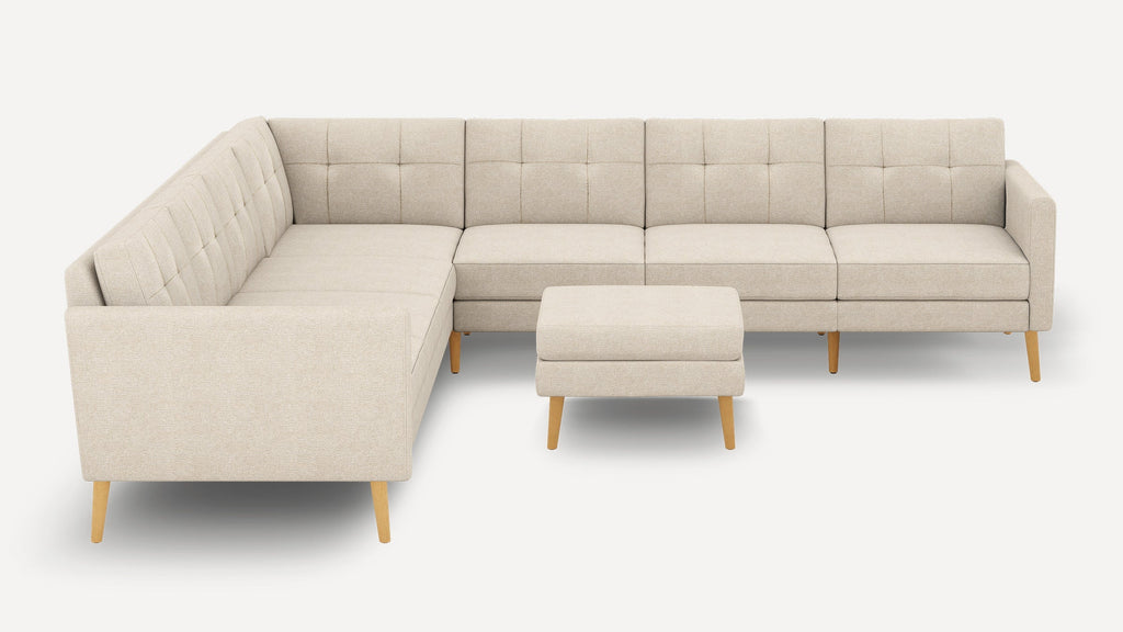 Beige fabric sectional sofa with tufted back cushions, wooden legs, and matching ottoman, modern minimalist design.