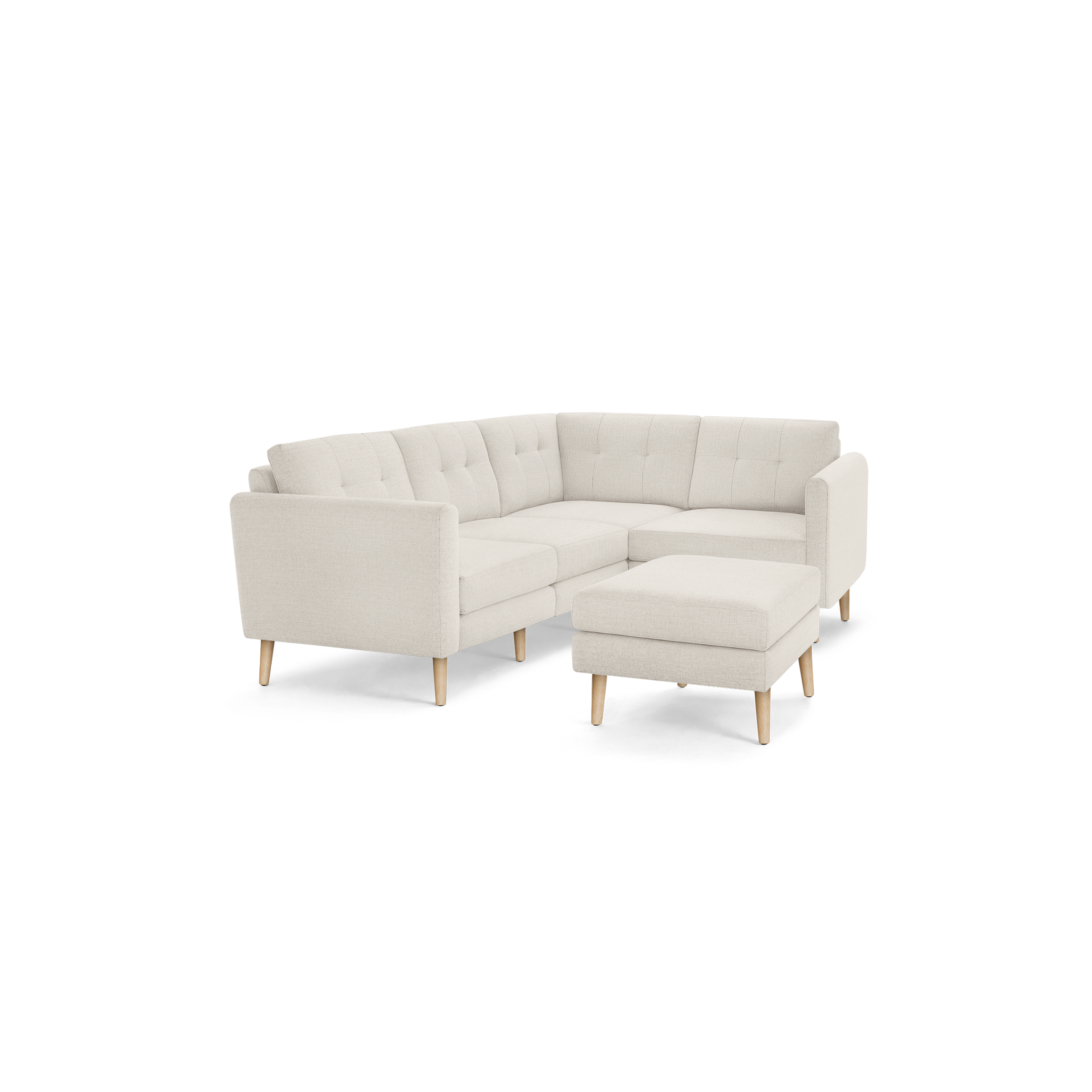 Beige L-shaped sectional sofa with tufted cushions and wooden legs, accompanied by a matching ottoman.