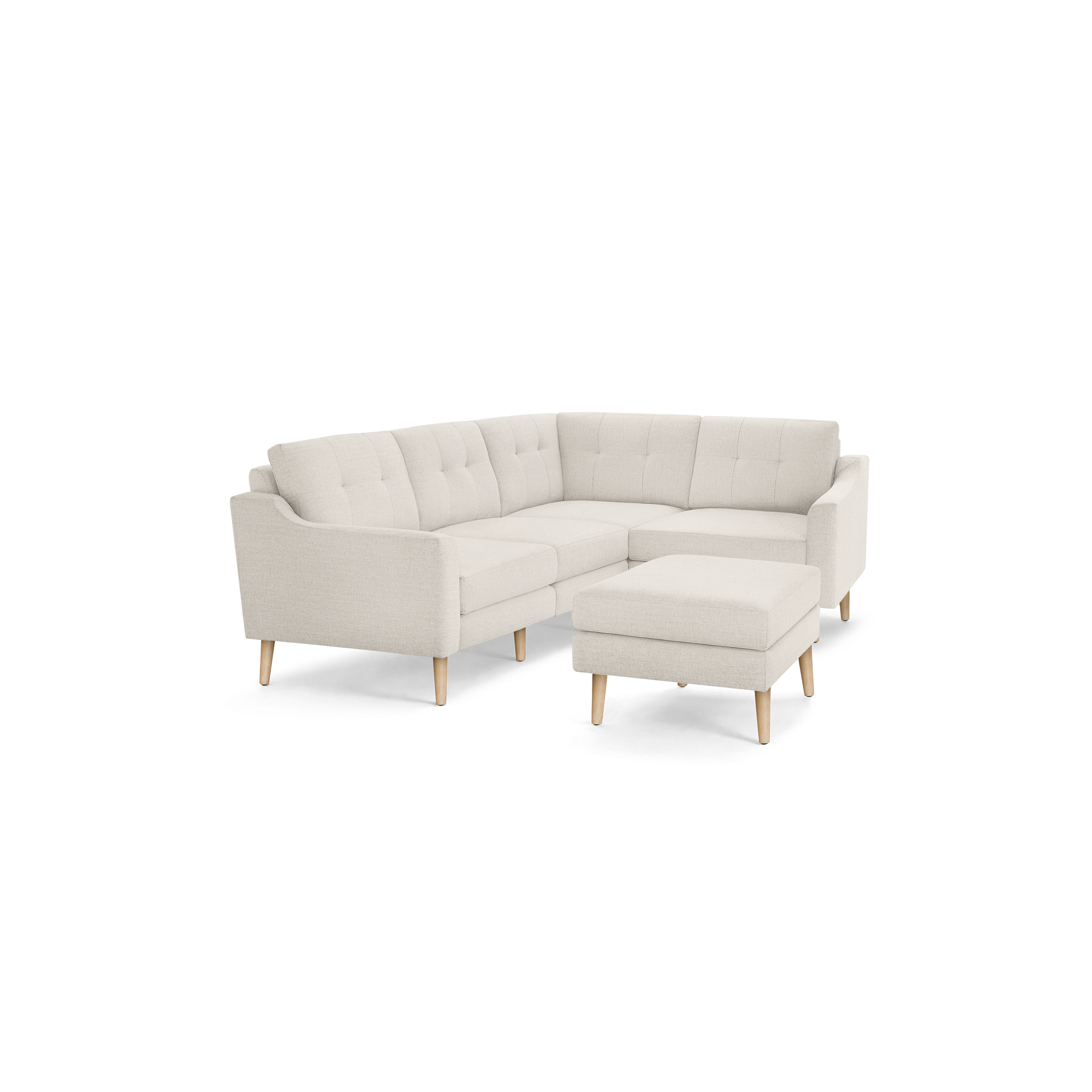 Beige fabric L-shaped sectional sofa with tufted back cushions and light wooden legs, paired with a matching ottoman.