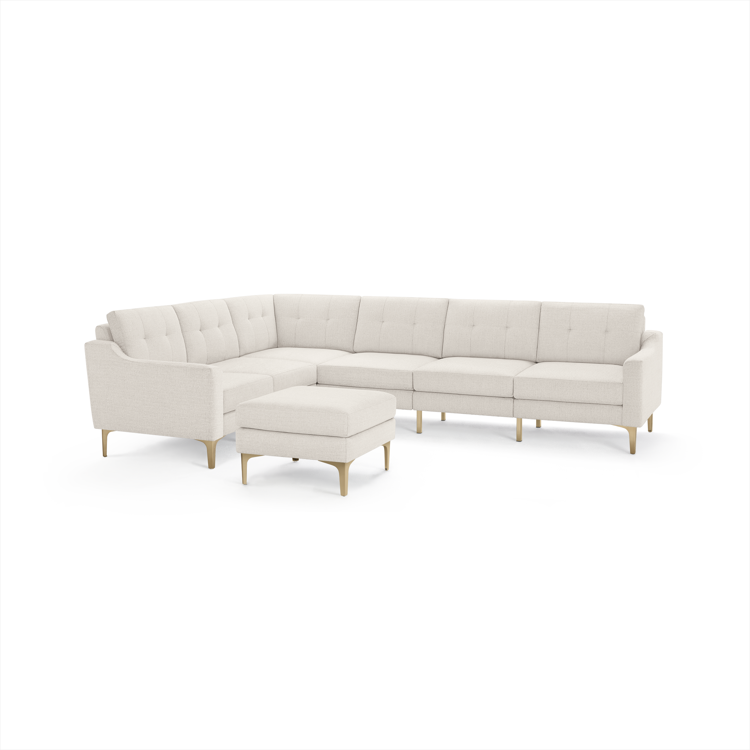 Cream-colored modern sectional sofa with tufted back cushions and matching ottoman, set on light wooden legs.