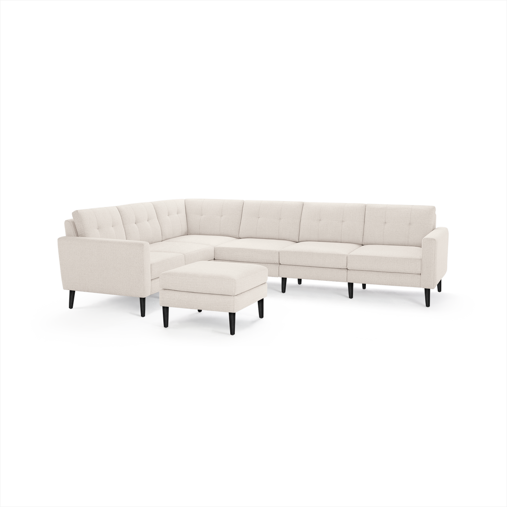 Beige tufted fabric sectional sofa with left corner, clean lines, and matching ottoman on black tapered legs.