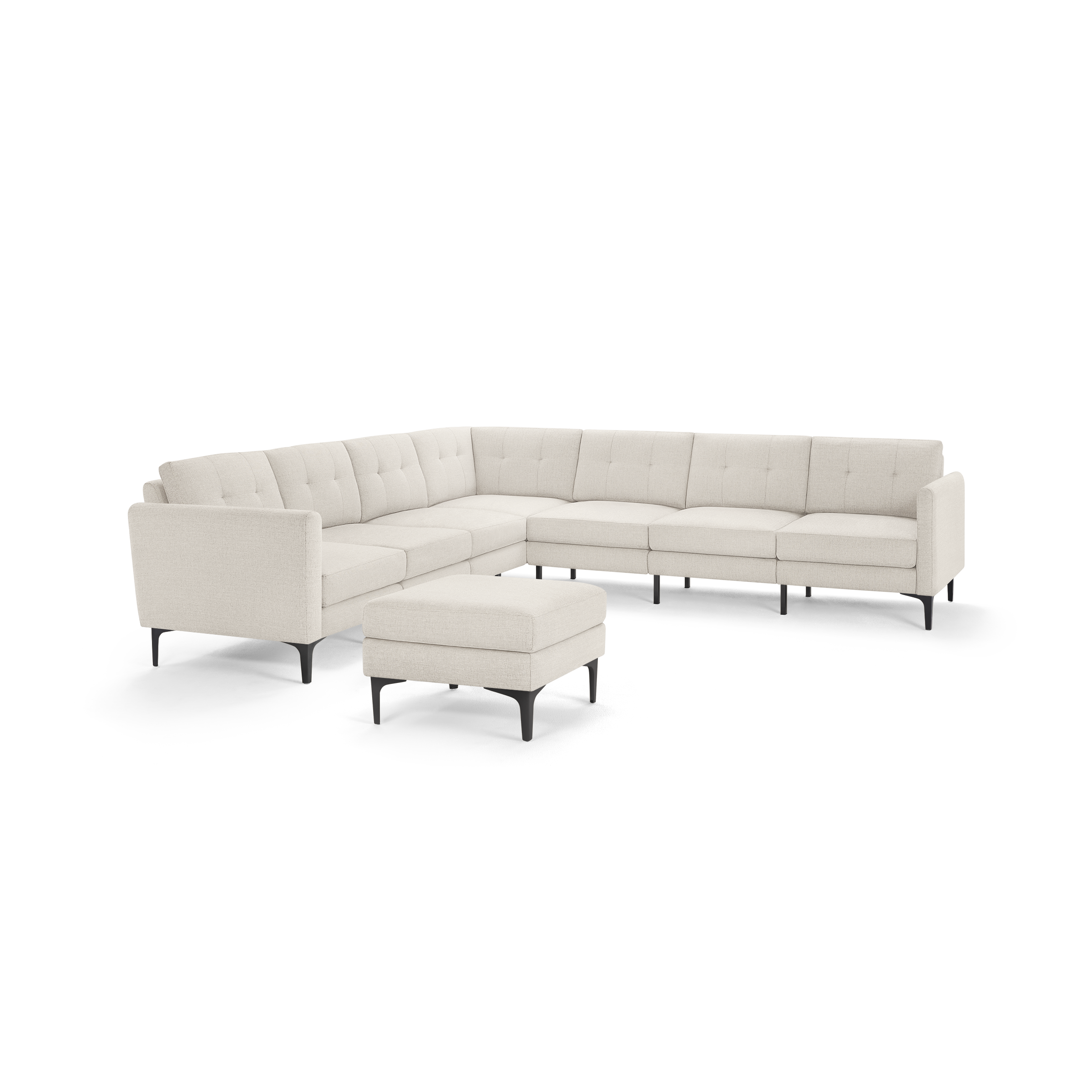 Light beige L-shaped sectional sofa with tufted cushions and black slender legs, paired with a matching ottoman.
