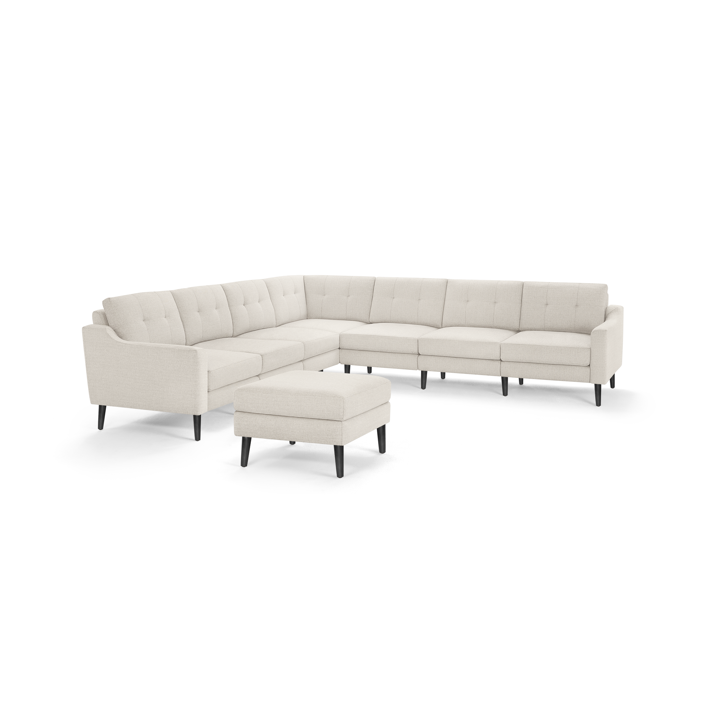 Beige fabric sectional sofa with tufted cushions, black tapered legs, and a matching ottoman.