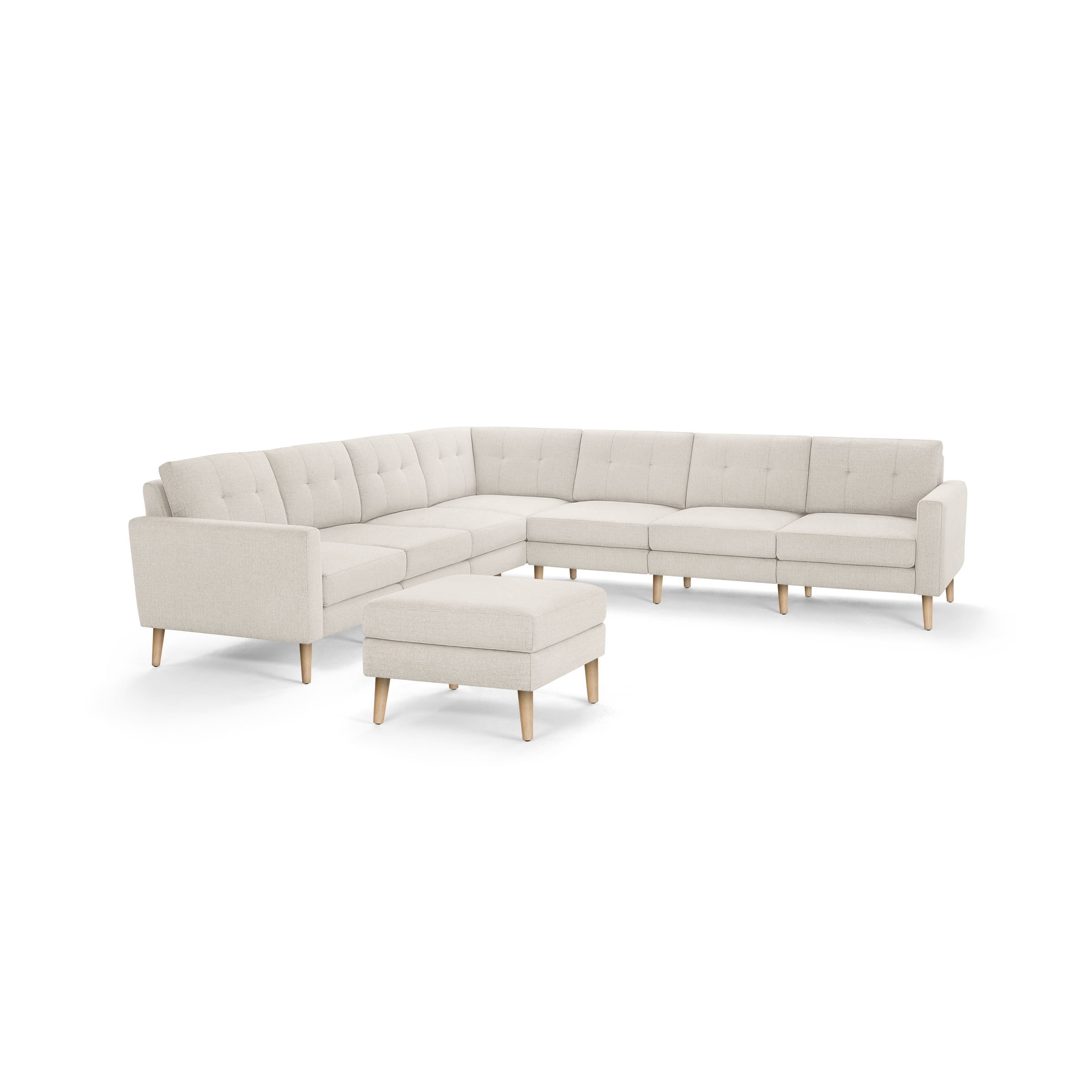 Beige L-shaped sectional sofa with tufted cushions, wooden legs, and matching ottoman, designed for modern living spaces.