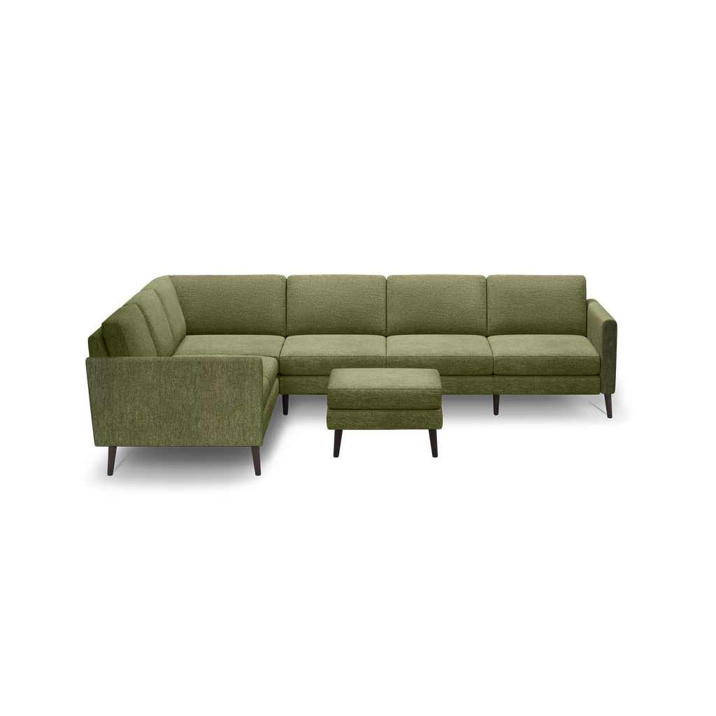 Olive green sectional sofa with an L-shape design, matching square ottoman, and dark wooden legs, set against a black background.