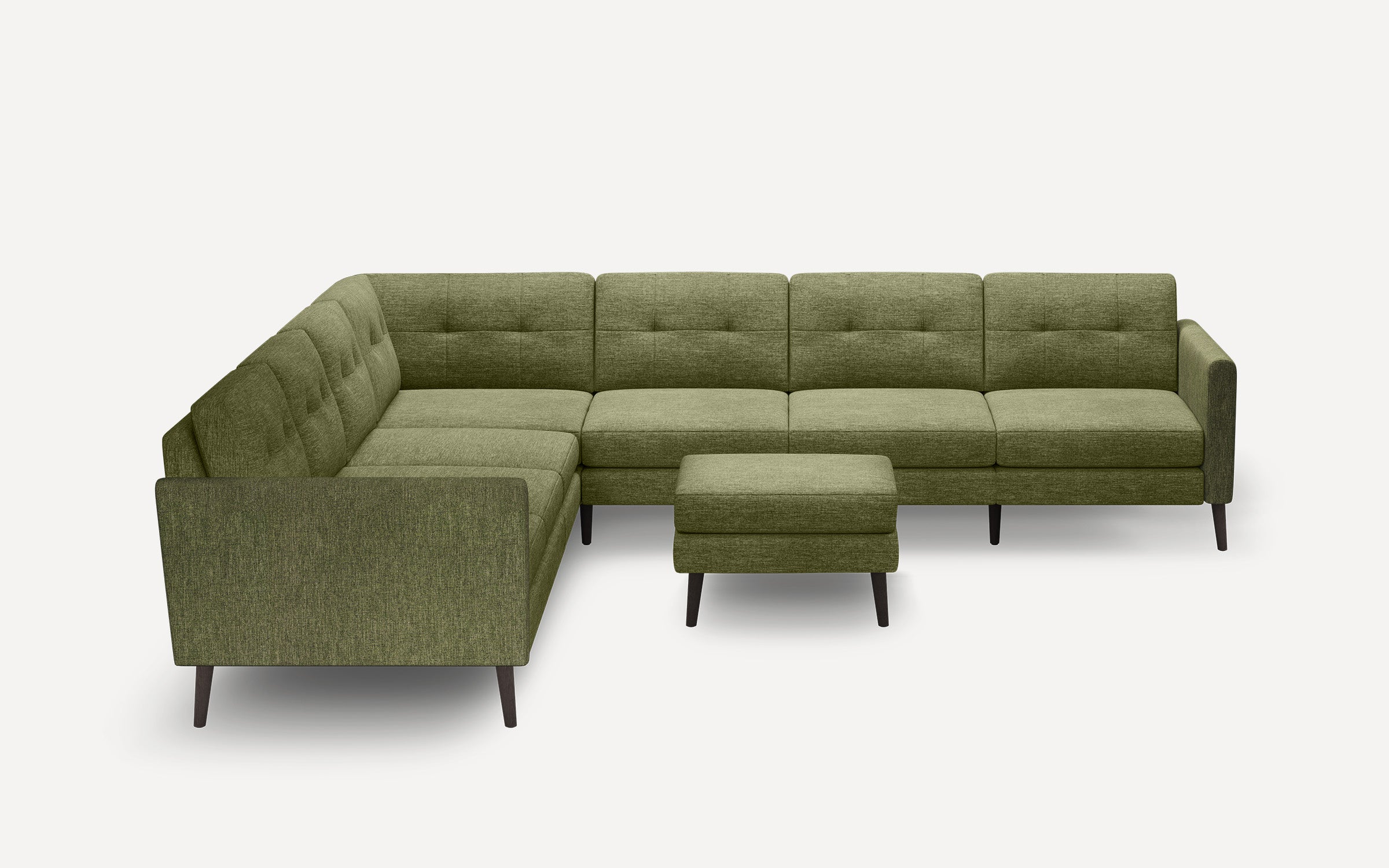 Modern L-shaped sectional sofa in olive green fabric with button tufting, accompanied by a matching ottoman, on dark tapered legs.