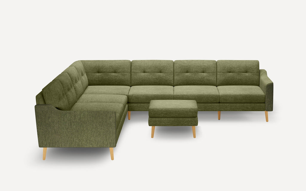 Olive green fabric sectional sofa with tufted cushions and matching ottoman, featuring light wooden legs and a modern design.