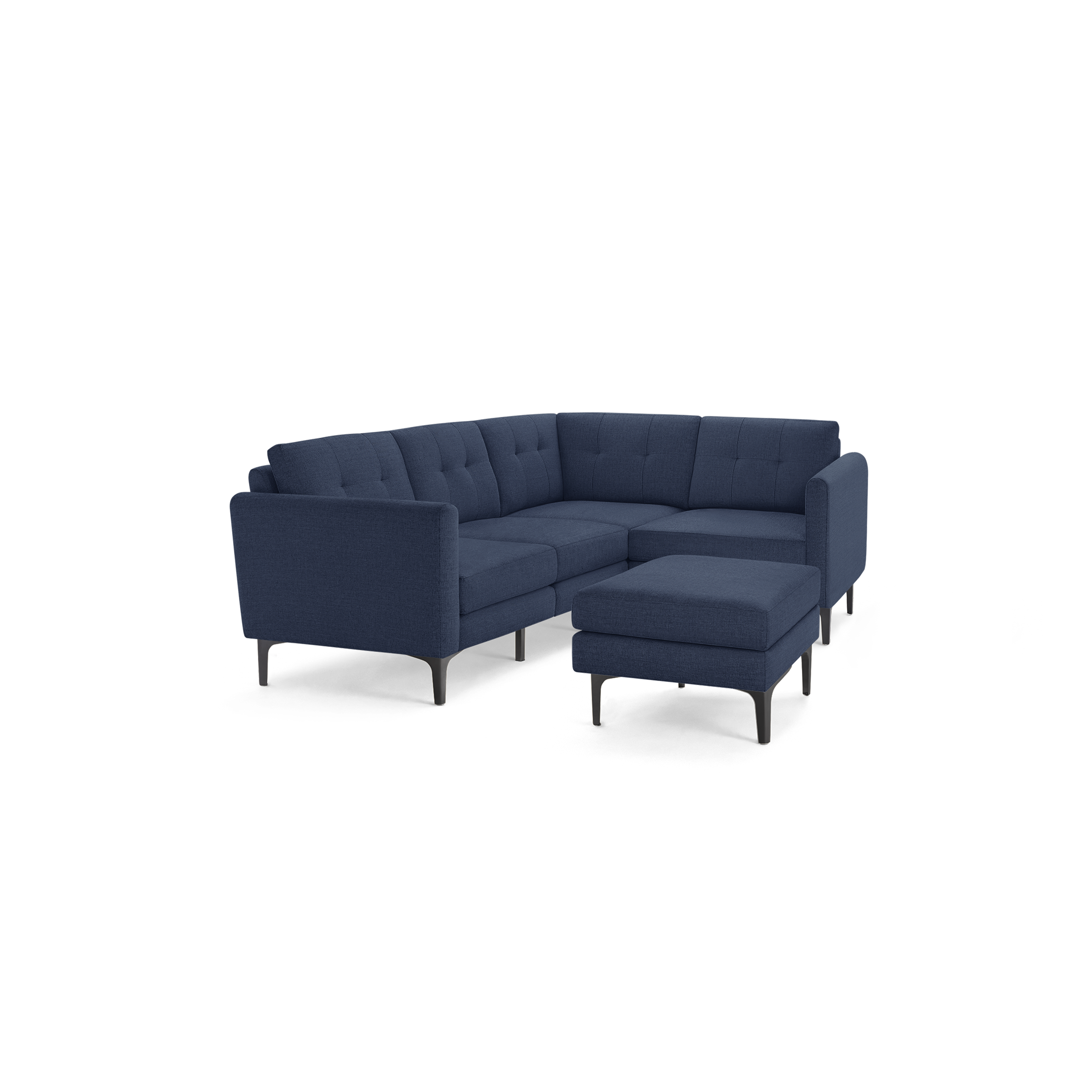 Mid-century modern sectional sofa in navy blue fabric with tufted cushions and black tapered legs, including a matching ottoman.