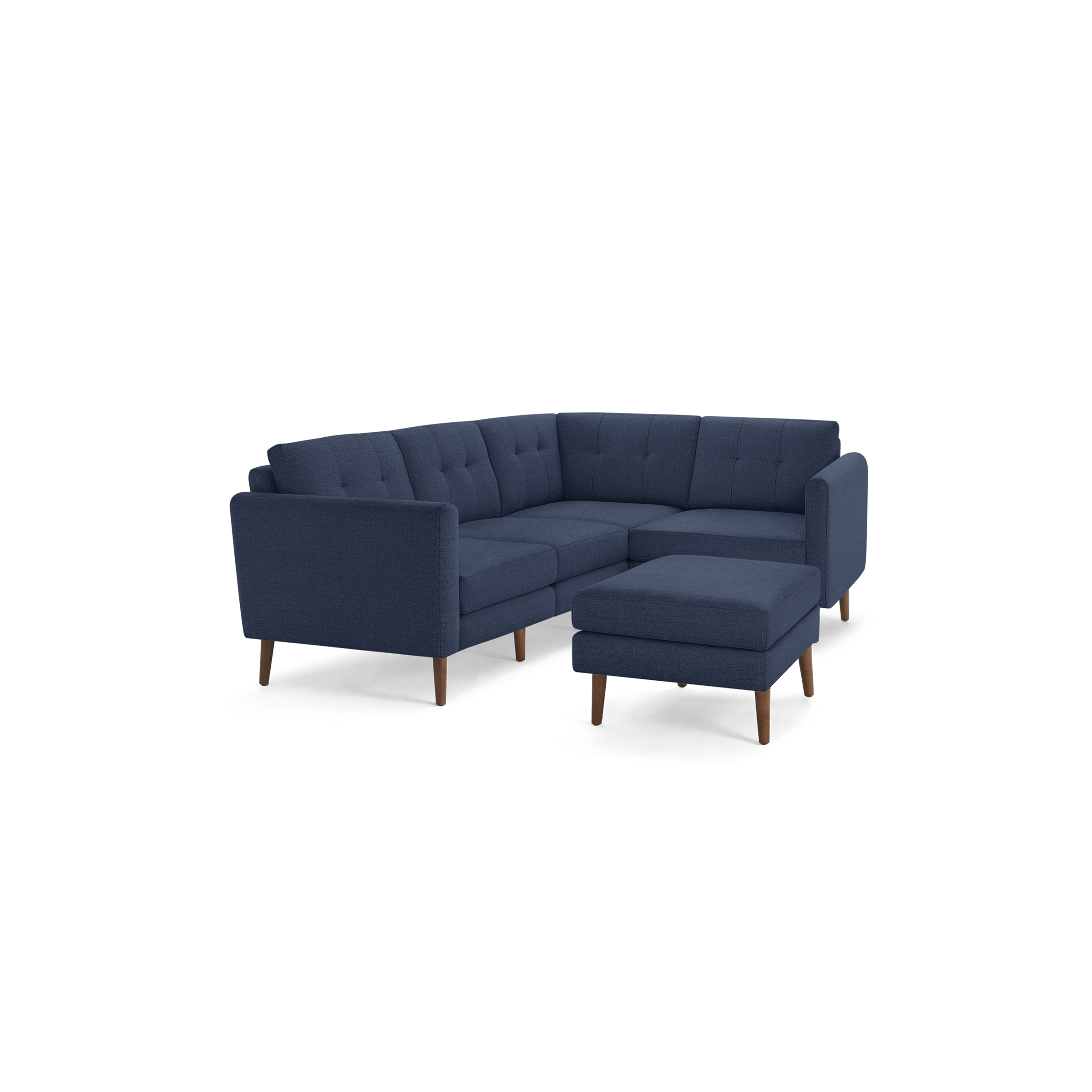 Modern navy blue fabric sectional sofa with tufted back cushions, wooden legs, and a matching ottoman on a black background.