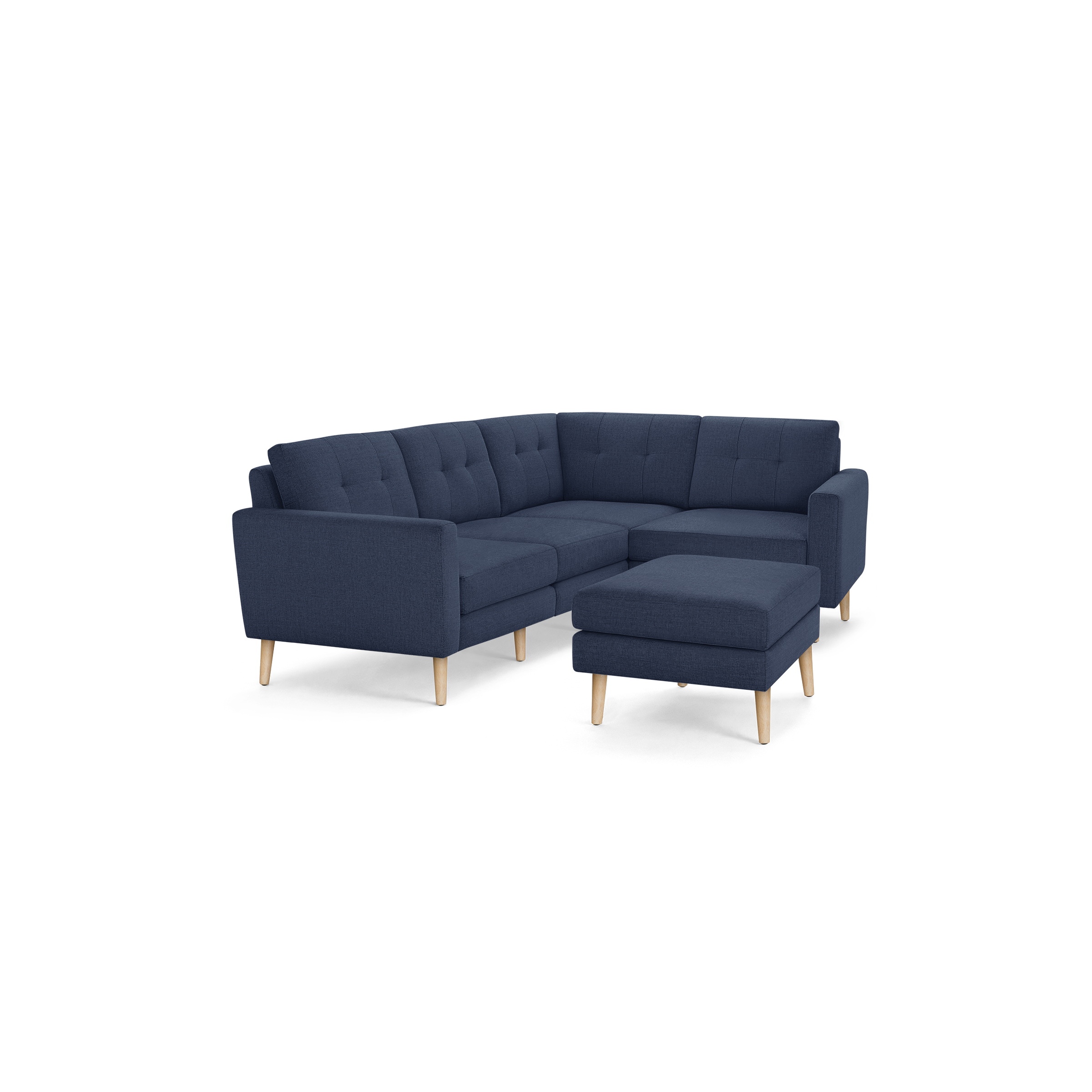 Modern navy blue fabric sectional sofa with tufted cushions, wooden legs, and matching ottoman isolated on black background.
