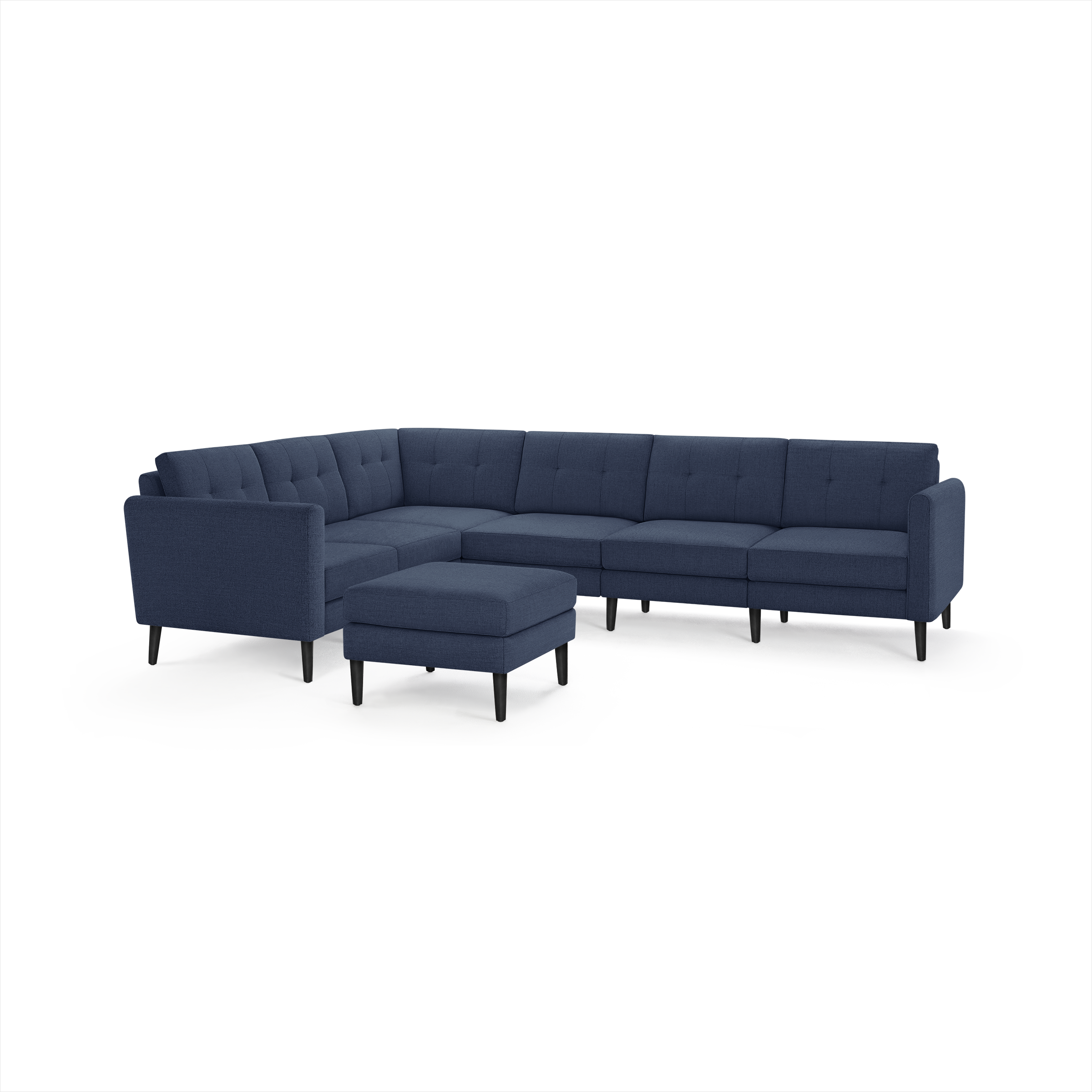 Modern navy blue L-shaped sectional sofa with tufted cushions and matching square ottoman, supported by black wooden legs.