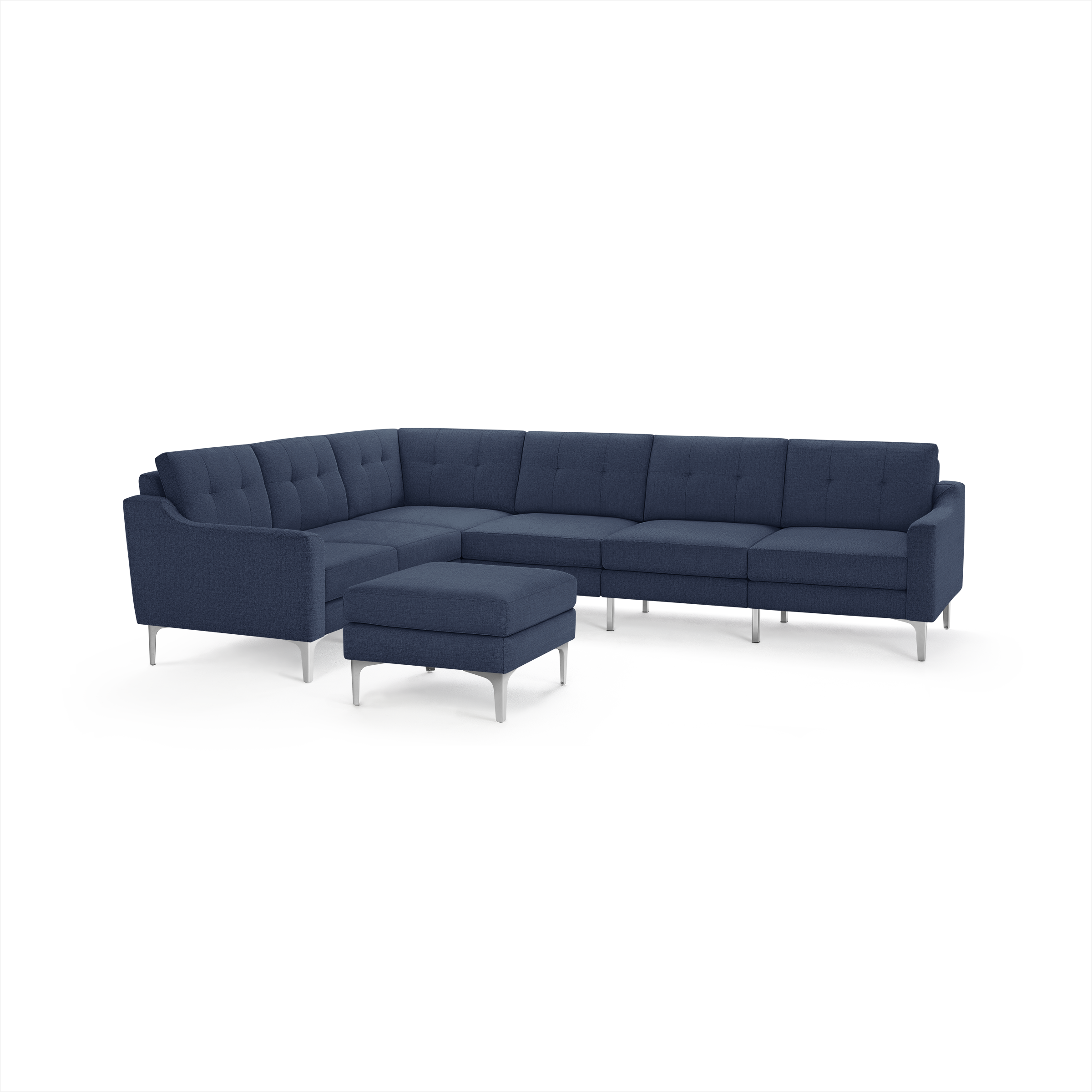 Modern dark blue fabric sectional sofa with tufted back cushions, silver metal legs, and matching ottoman.
