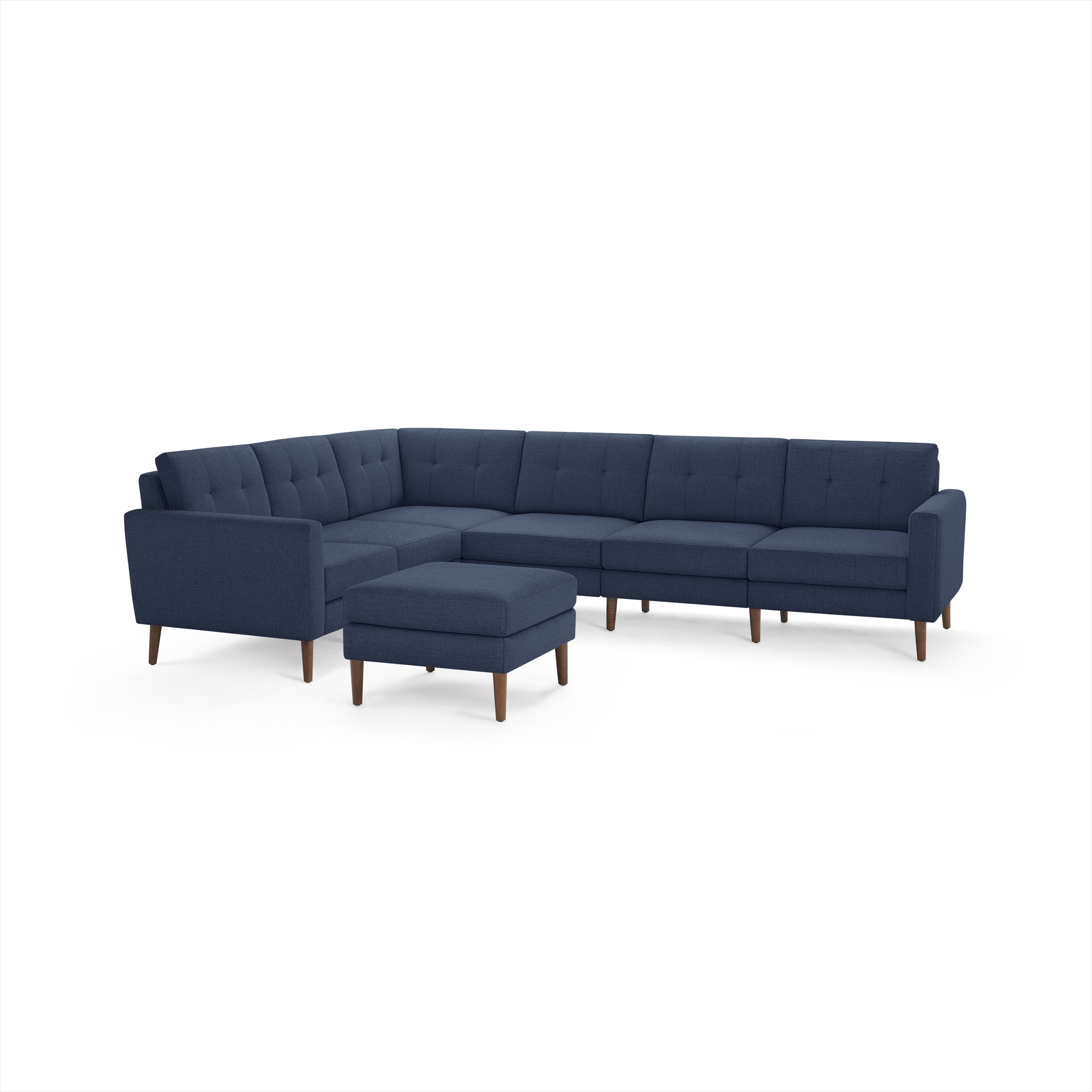 Modern navy blue fabric sectional sofa with tufted cushions and matching ottoman, supported by wooden legs.