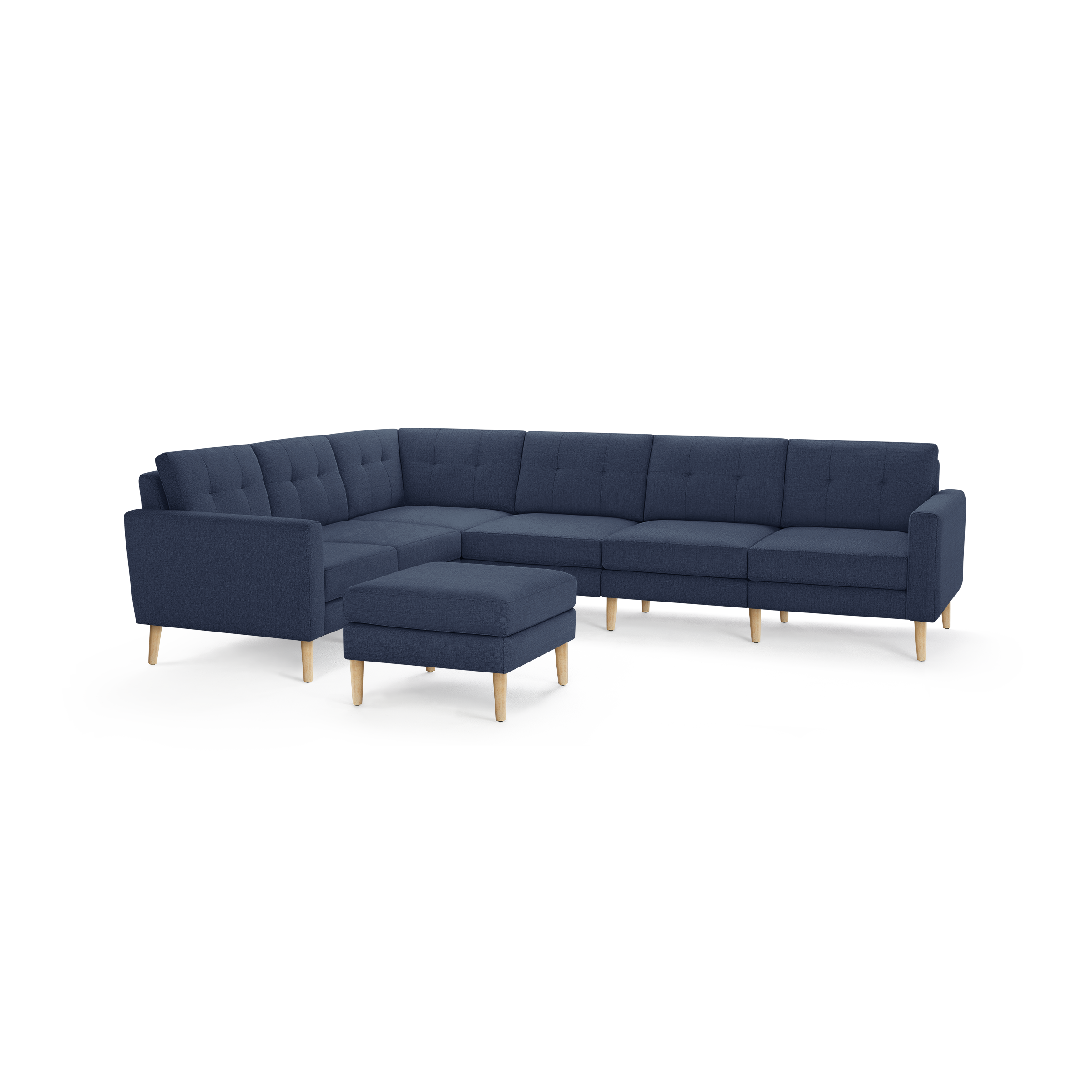 Modern navy blue sectional sofa with tufted back cushions, wooden legs, and a matching ottoman on a white background.