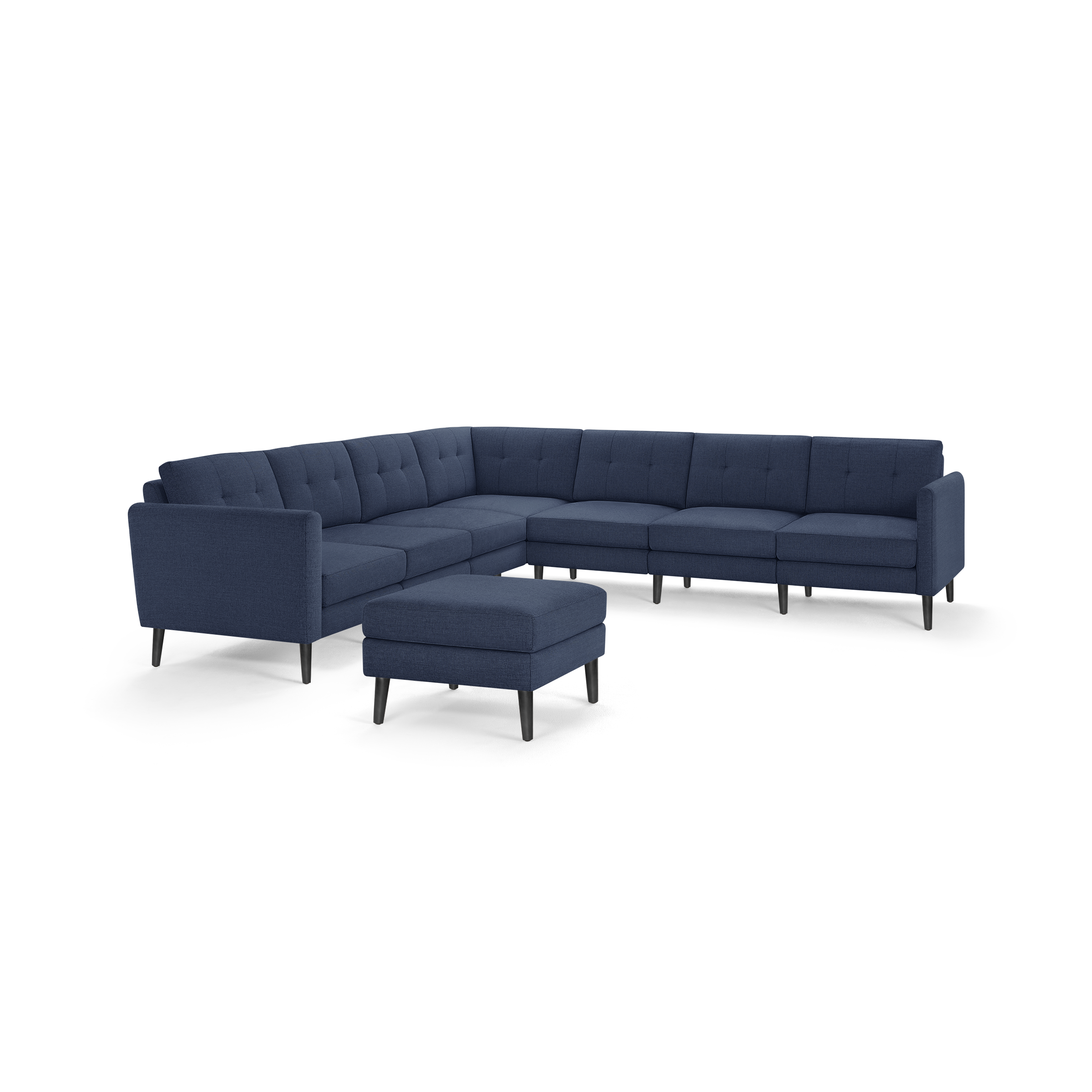 Modern navy blue fabric L-shaped sectional sofa with button-tufted back cushions and matching ottoman on black tapered legs.