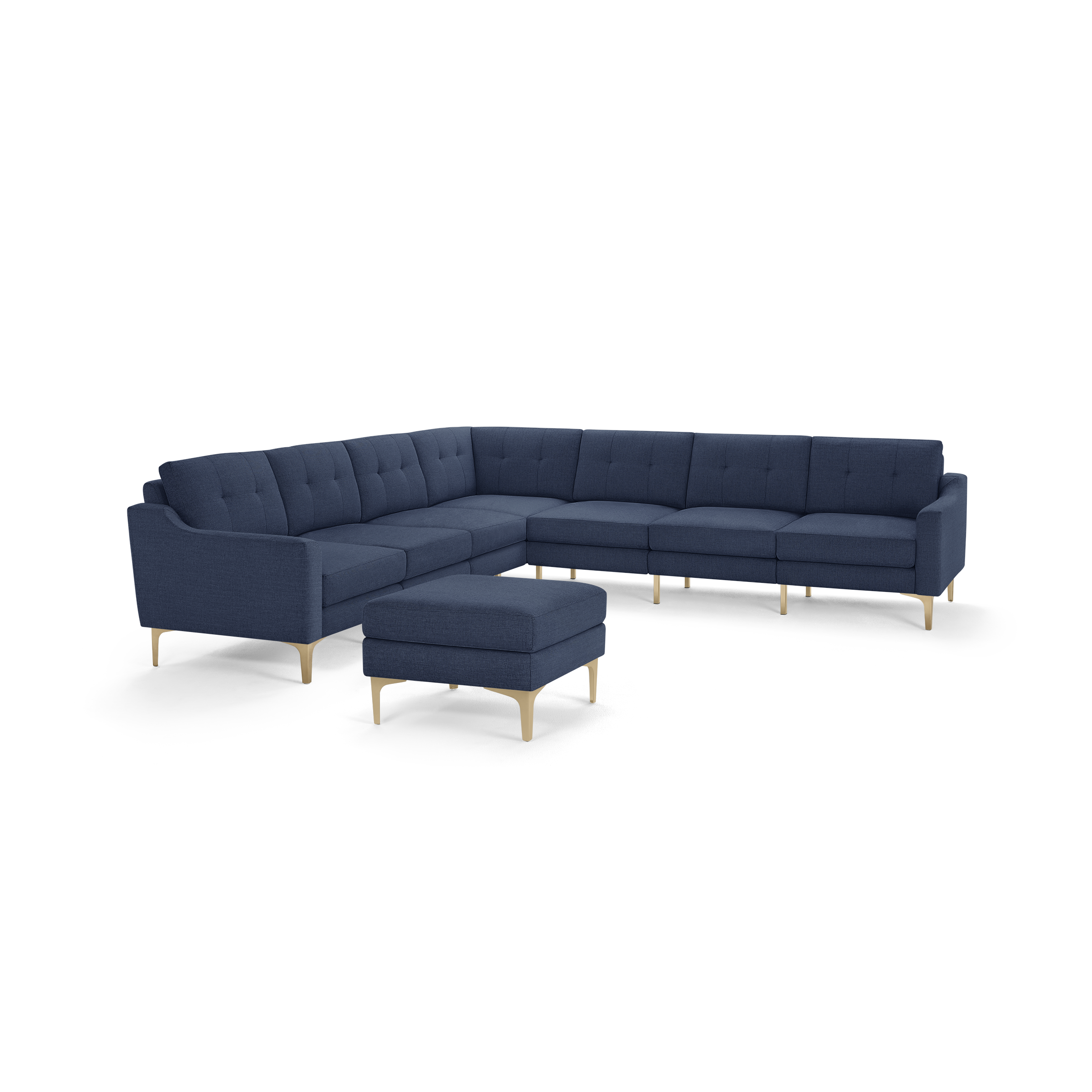 Large modern L-shaped sectional sofa with deep blue fabric upholstery, tufted cushions, slim armrests, light wooden legs, and a matching square ottoman.