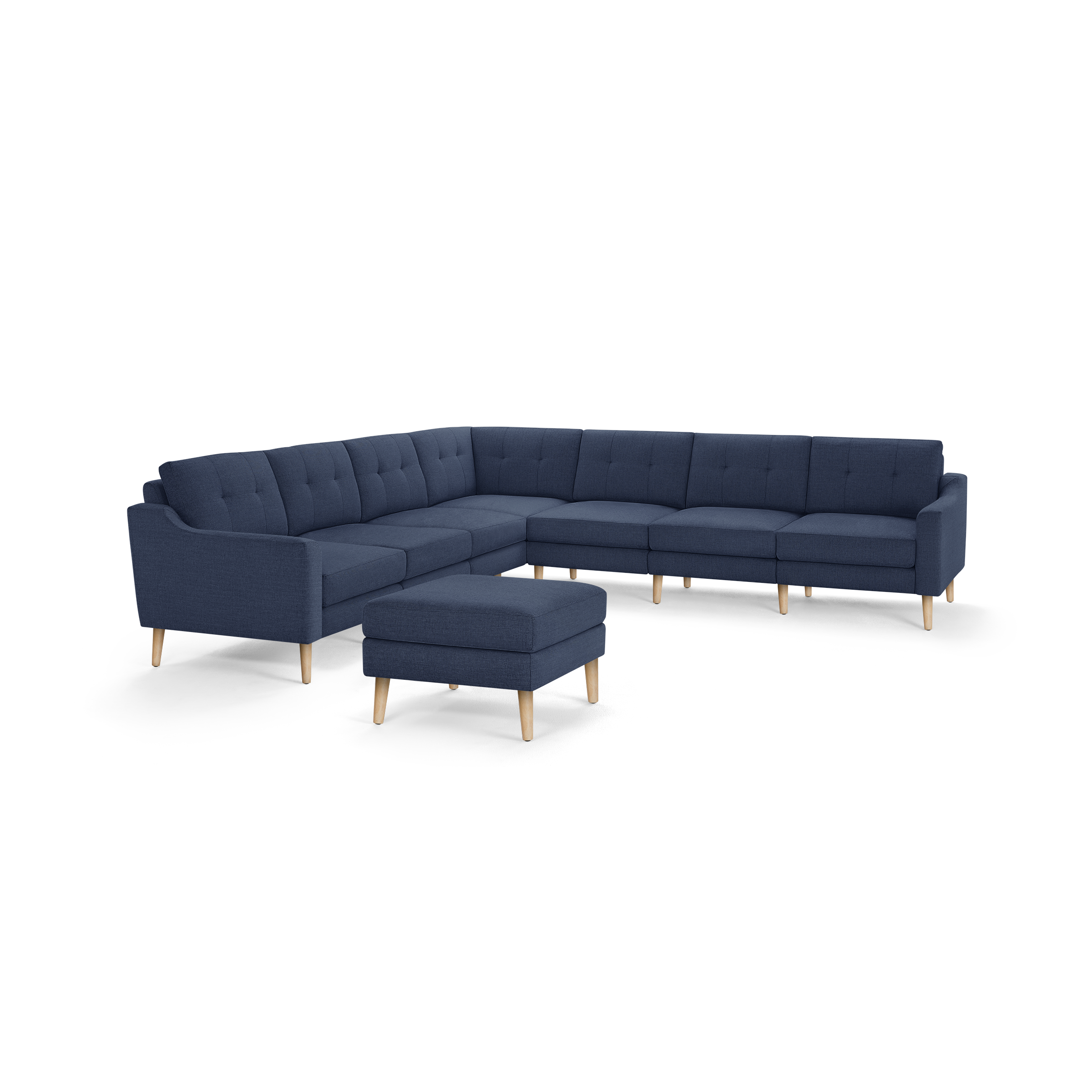Modern navy blue fabric sectional sofa with tufted back cushions, wooden legs, and a matching ottoman on a white background.