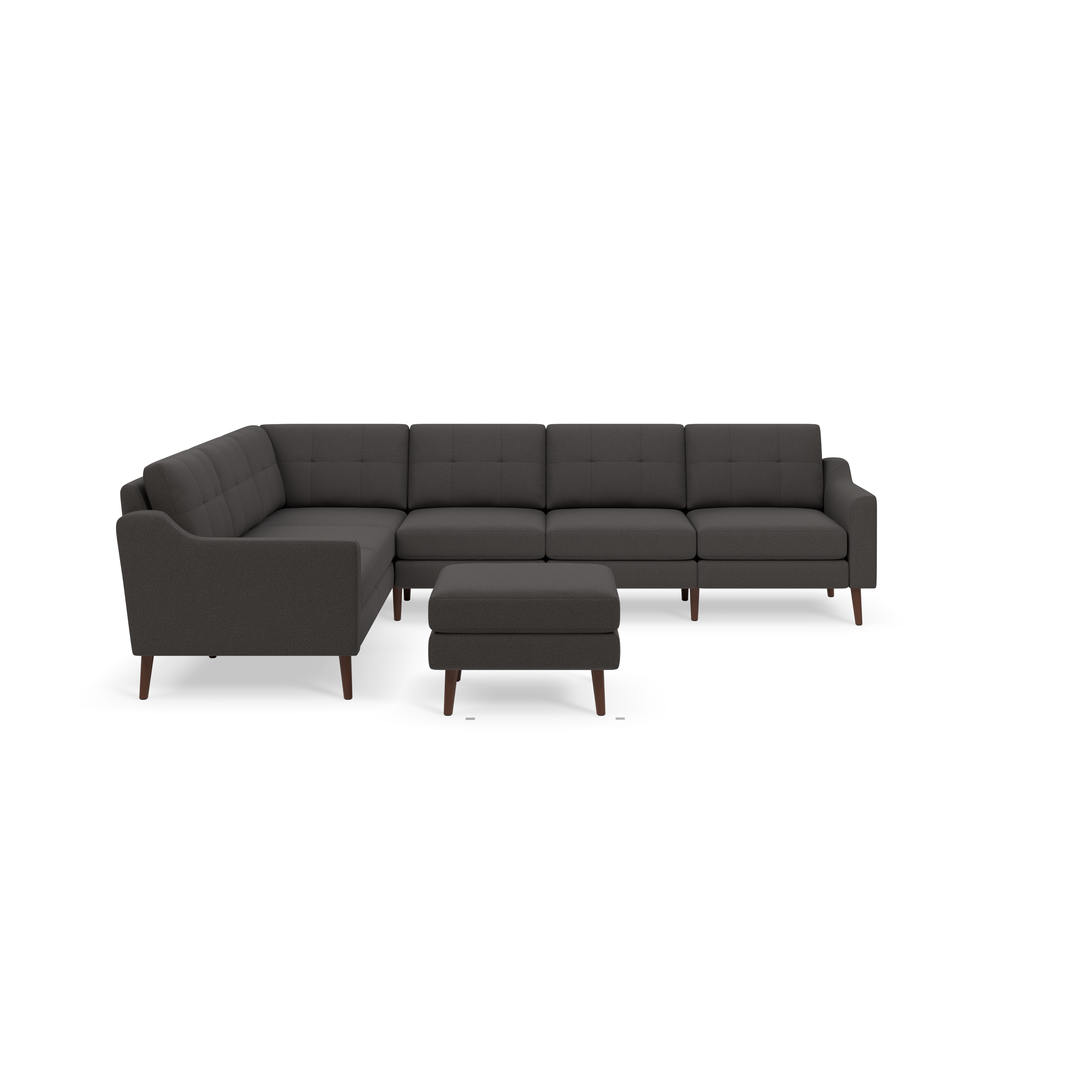 Dark gray L-shaped sectional sofa with tufted cushions and matching ottoman, supported by wooden legs.