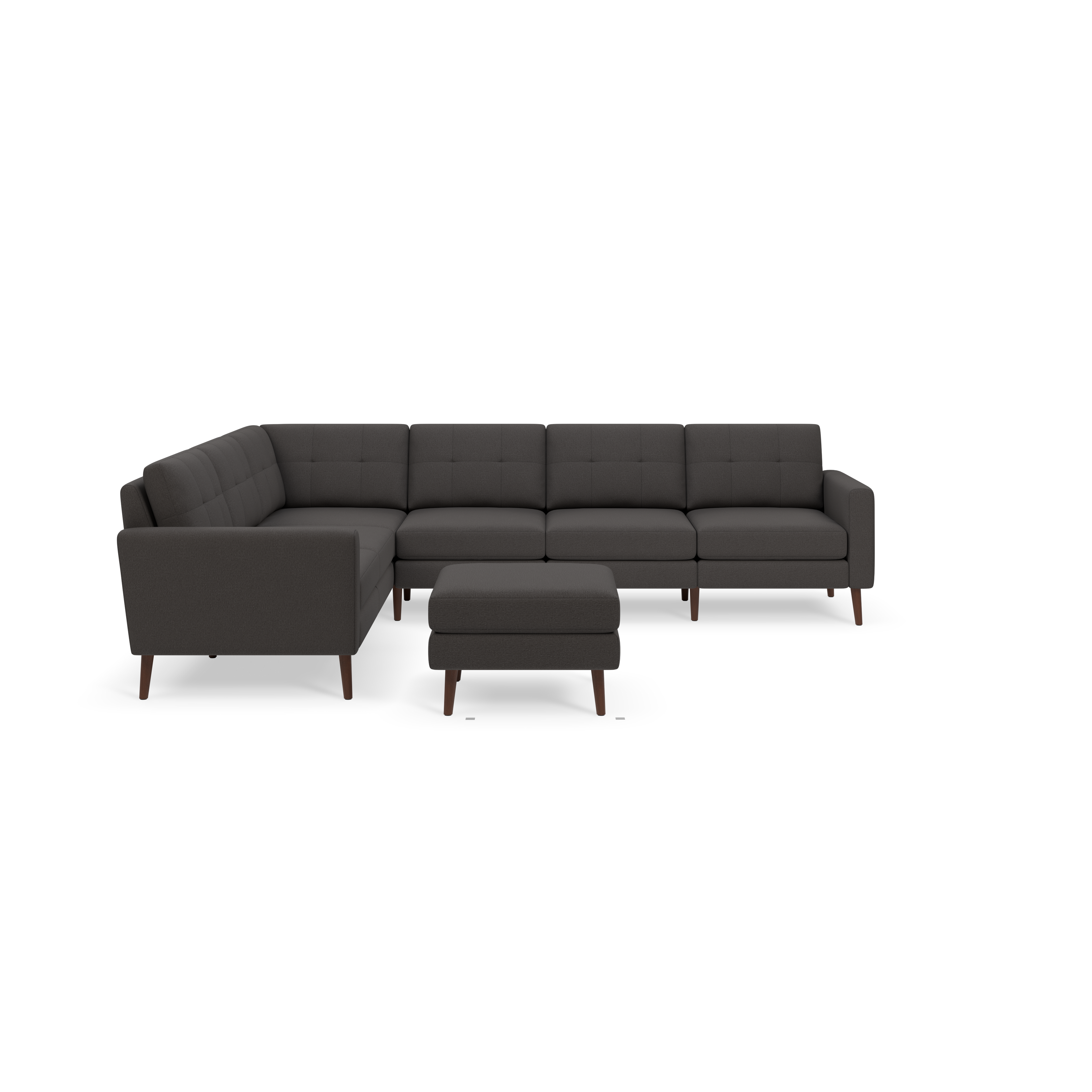 Dark gray L-shaped sectional sofa with tufted cushions and matching ottoman, supported by angled wooden legs.