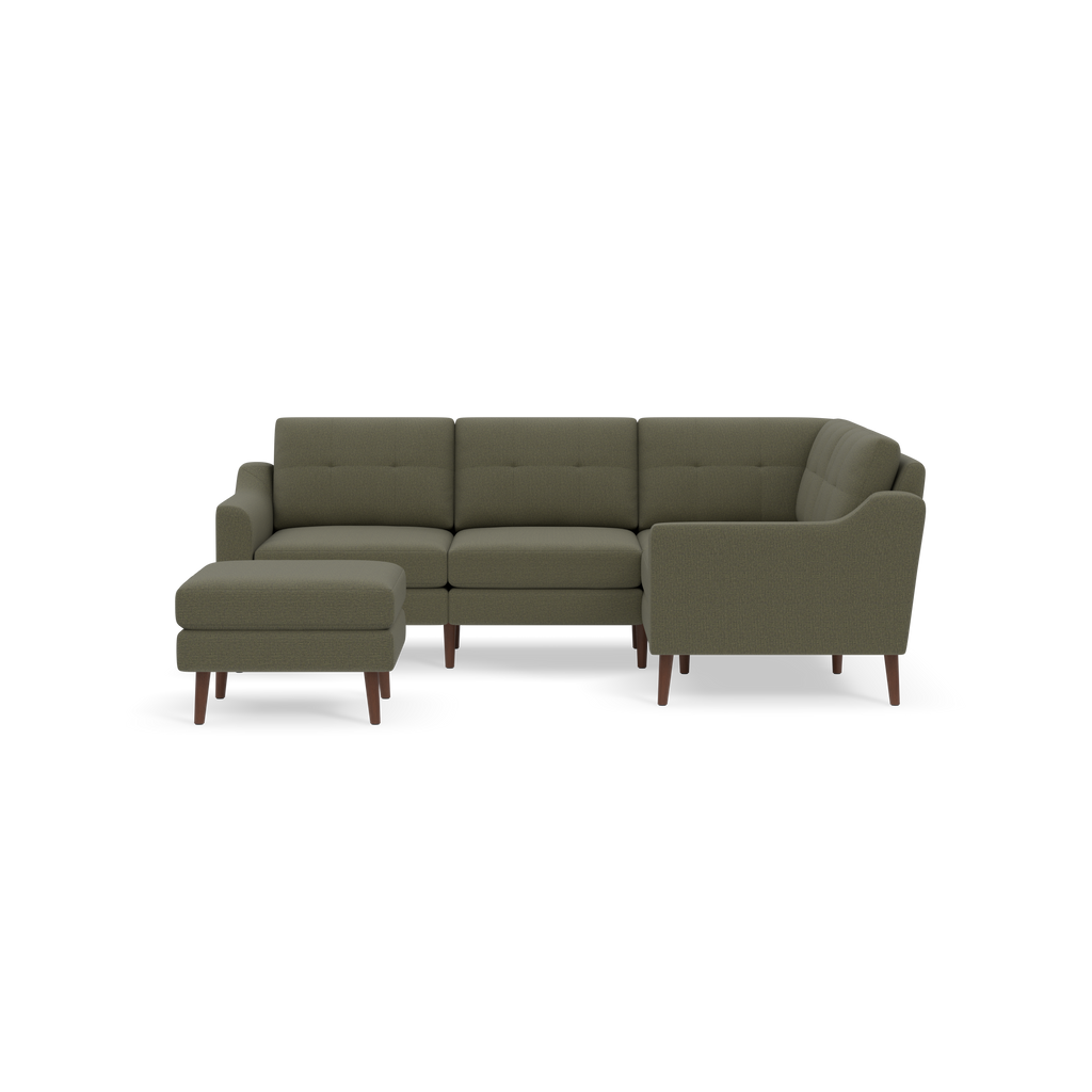 Olive green L-shaped sectional sofa with tufted cushions, rounded arms, wooden legs, and a matching ottoman on black background.