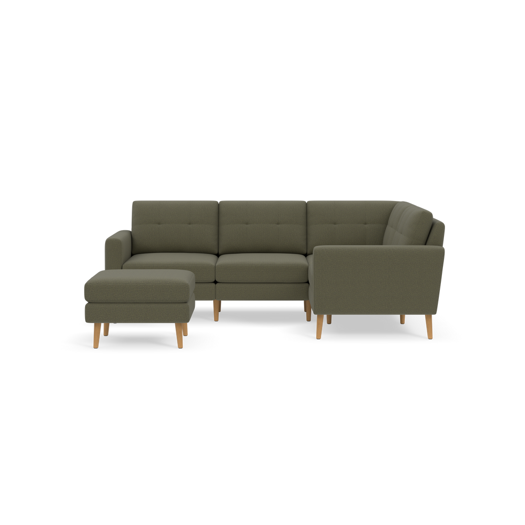 Olive green L-shaped sectional sofa with tufted cushions and light wooden legs, accompanied by matching ottoman.