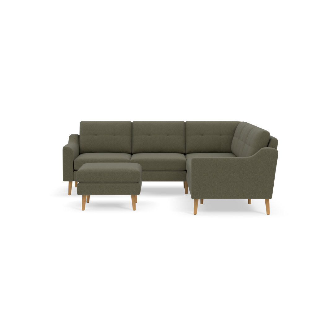 L-shaped Moss green fabric sectional sofa with button-tufted cushions, wooden legs, and a matching ottoman against black background.