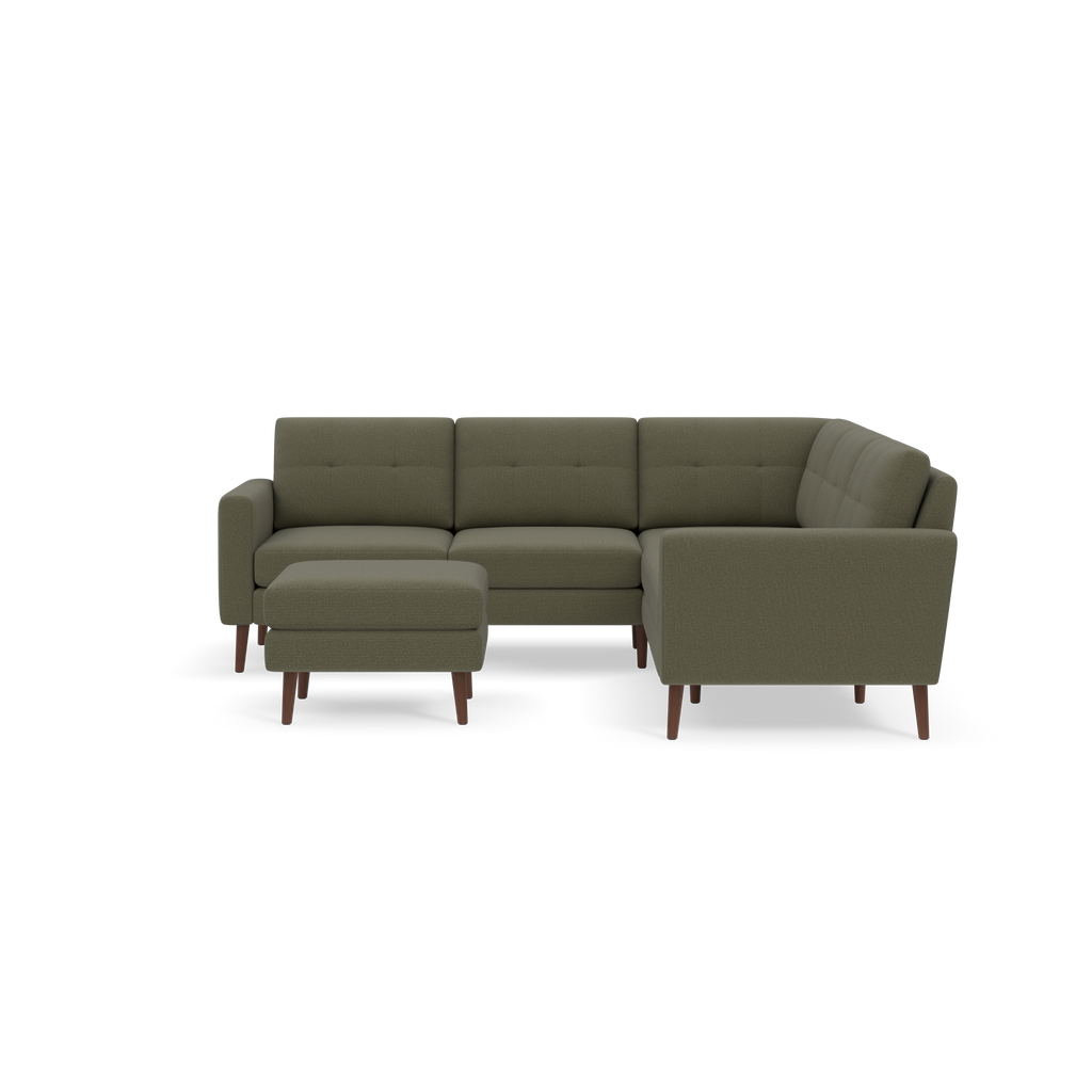 Olive green sectional sofa with tufted cushions and wooden legs, including a matching ottoman.