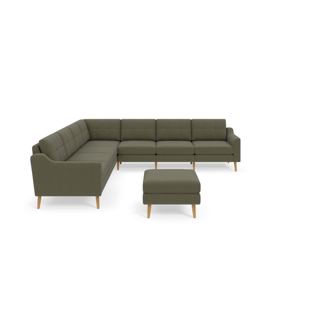 Gray-green L-shaped sectional sofa with wooden legs and matching ottoman, featuring tufted cushions and sleek armrests.