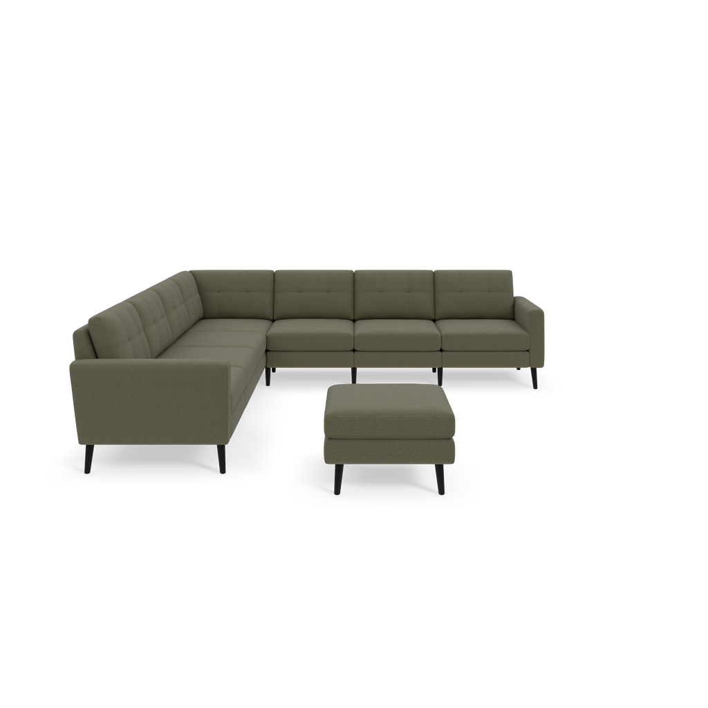 Moss green L-shaped sectional sofa with tufted cushions and matching ottoman, supported by black wooden legs, against black background.