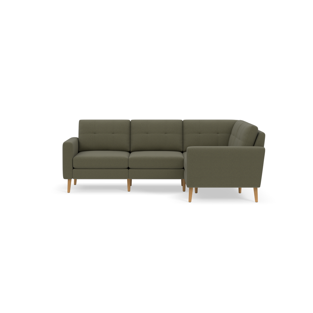 L-shaped sectional sofa with olive green fabric upholstery, tufted back cushions, and light wooden legs.