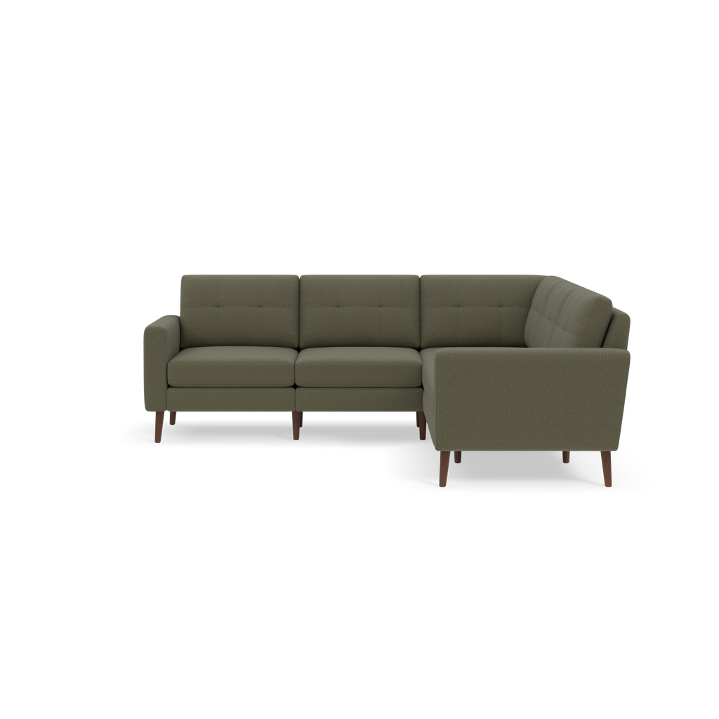 Mid-century modern L-shaped sectional sofa with olive green upholstery and wooden tapered legs against a black background.