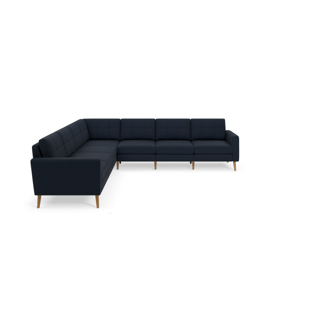 L-shaped dark navy blue sectional sofa with tufted cushions and light wooden legs, designed for modern living rooms.