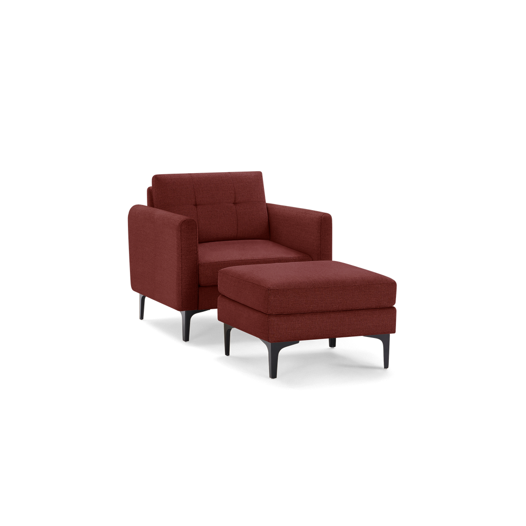 Modern armchair with matching ottoman in textured deep red fabric, featuring clean lines and black tapered legs.