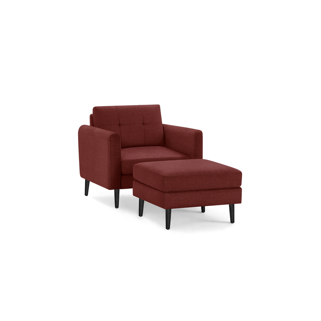 Red fabric armchair with matching ottoman, featuring tufted backrest and black tapered legs, modern and cozy design.