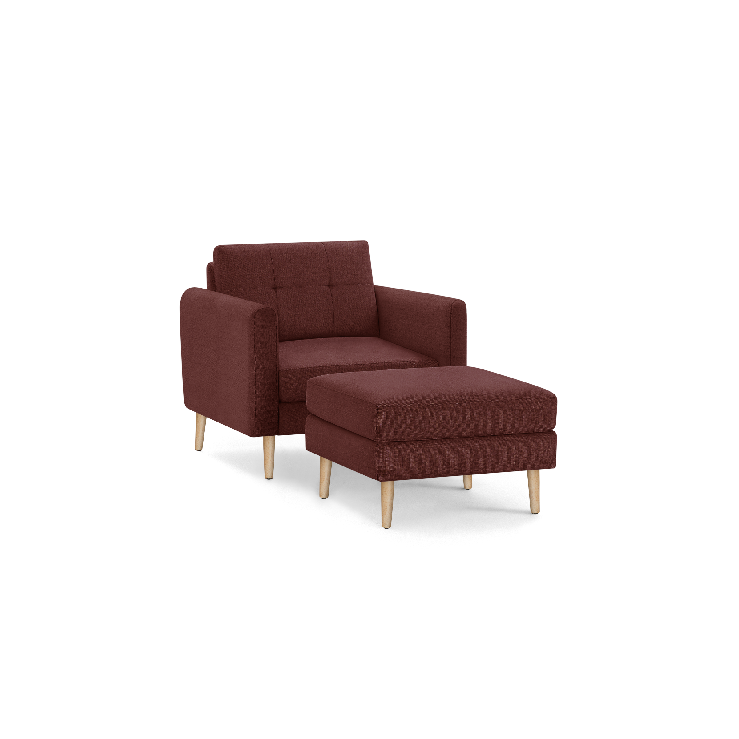 Modern red fabric armchair with matching ottoman, tufted backrest, and natural wooden legs, isolated on black background.