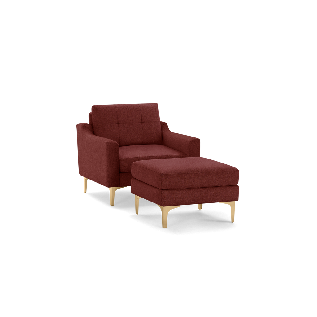 Modern deep red fabric armchair with matching ottoman, featuring tufted backrest and gold metal legs.