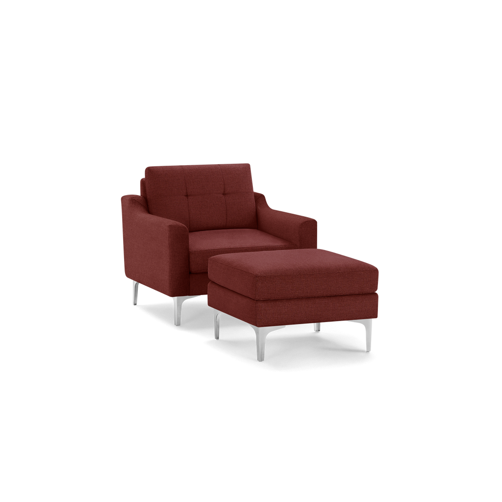 Modern deep red upholstered armchair with matching cushioned ottoman and sleek silver legs, designed for comfort and style.