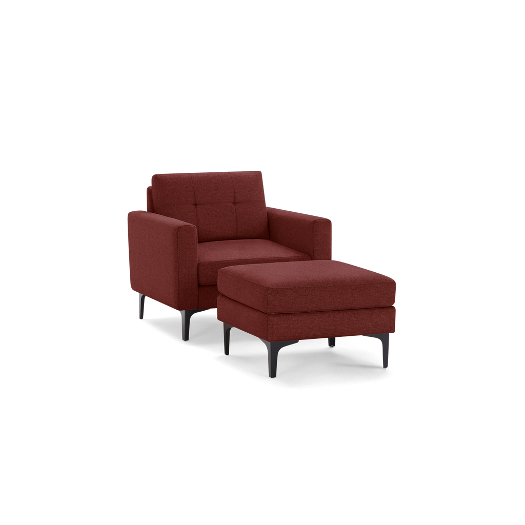 Modern rust-colored fabric armchair with matching cushioned ottoman, black tapered legs, and tufted backrest.