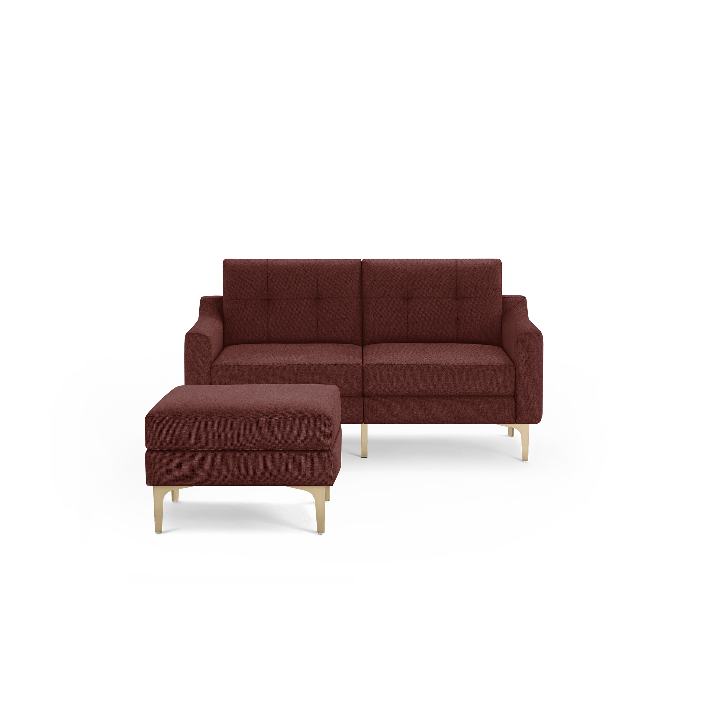 Modern two-seater sofa and matching ottoman in deep red fabric with tufted cushions and light wooden legs, isolated on black background.
