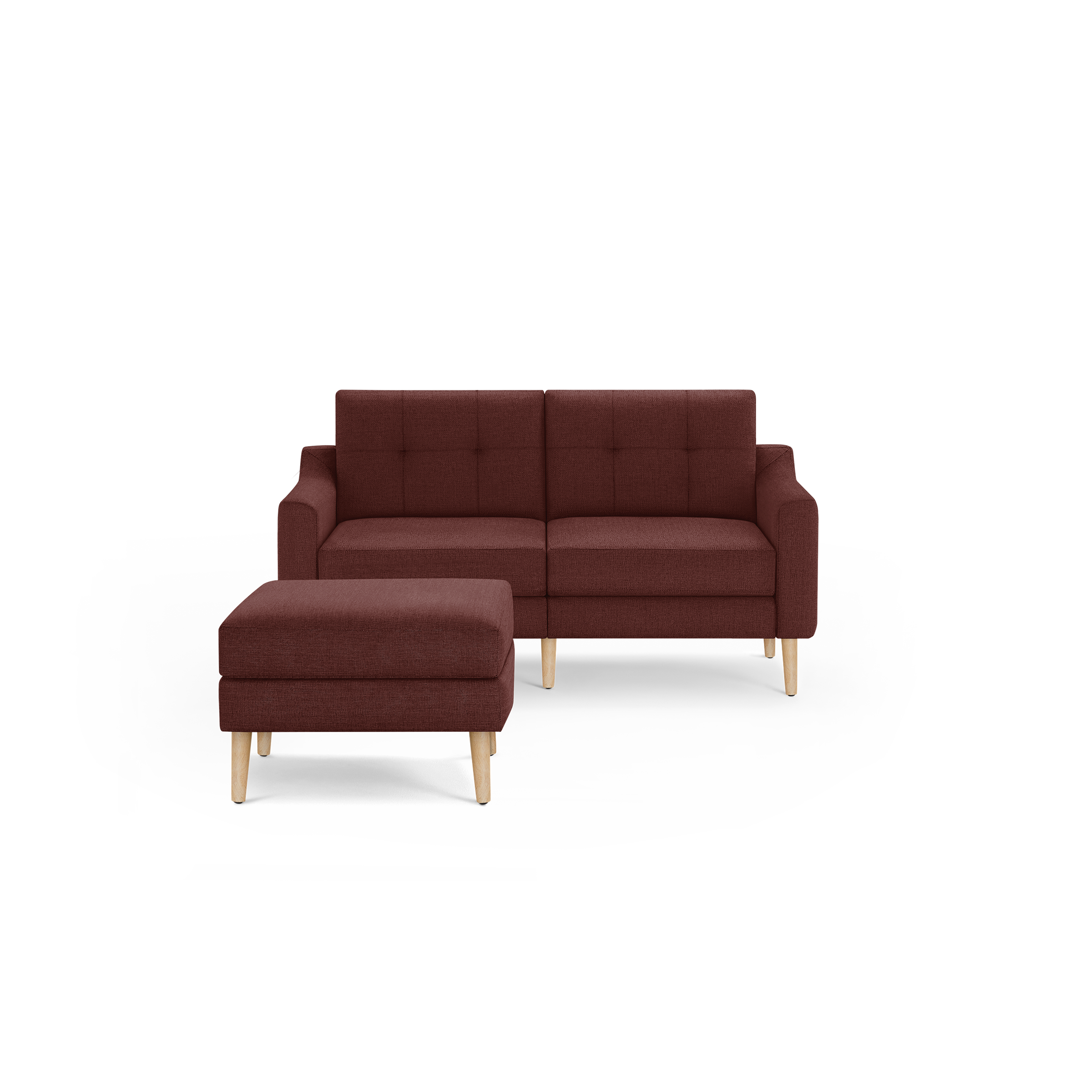 Modern mid-century style two-seater sofa and ottoman in deep burgundy fabric with light wooden legs and tufted backrest cushions.