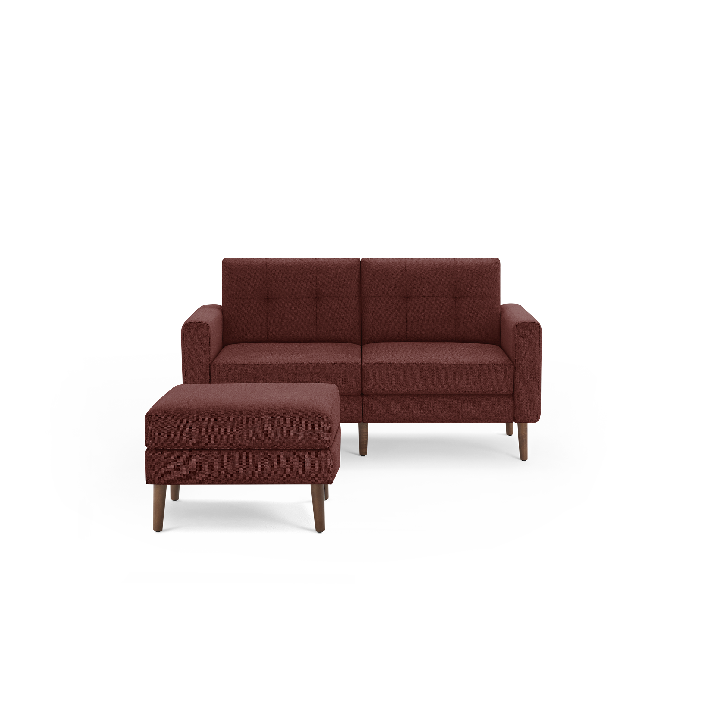 Mid-century style two-seater sofa and matching ottoman in rust-colored fabric with wooden legs and tufted back cushions.