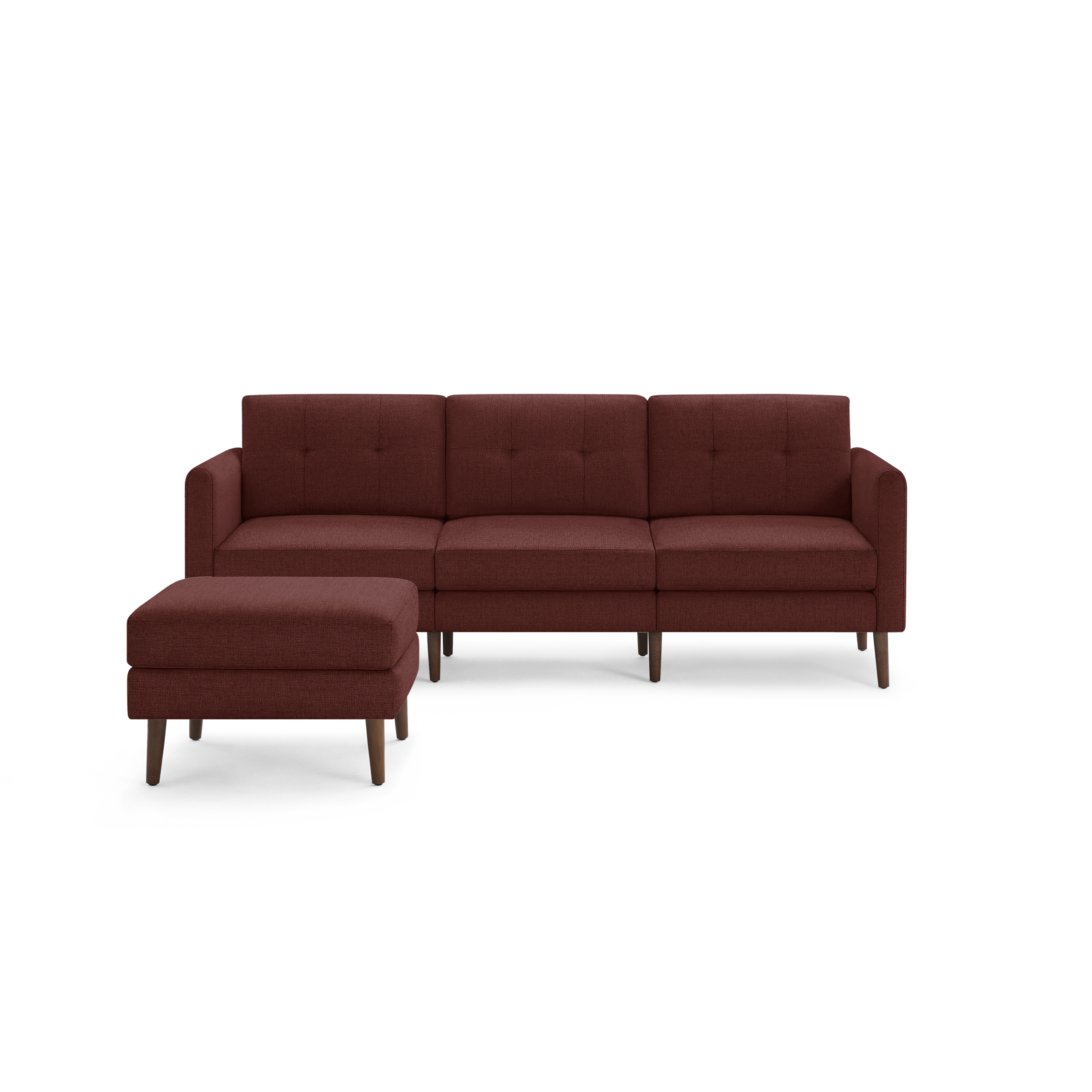 Modern three-seater sectional sofa with tufted cushions and matching ottoman, upholstered in dark red fabric with wooden tapered legs.