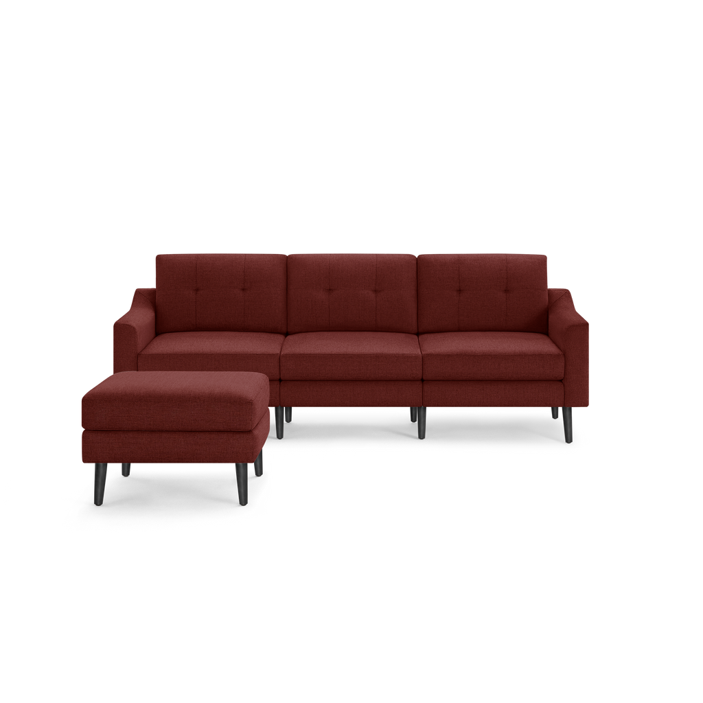 Modern mid-century style sectional sofa with matching ottoman, upholstered in deep red fabric with button-tufted back cushions and black tapered legs.