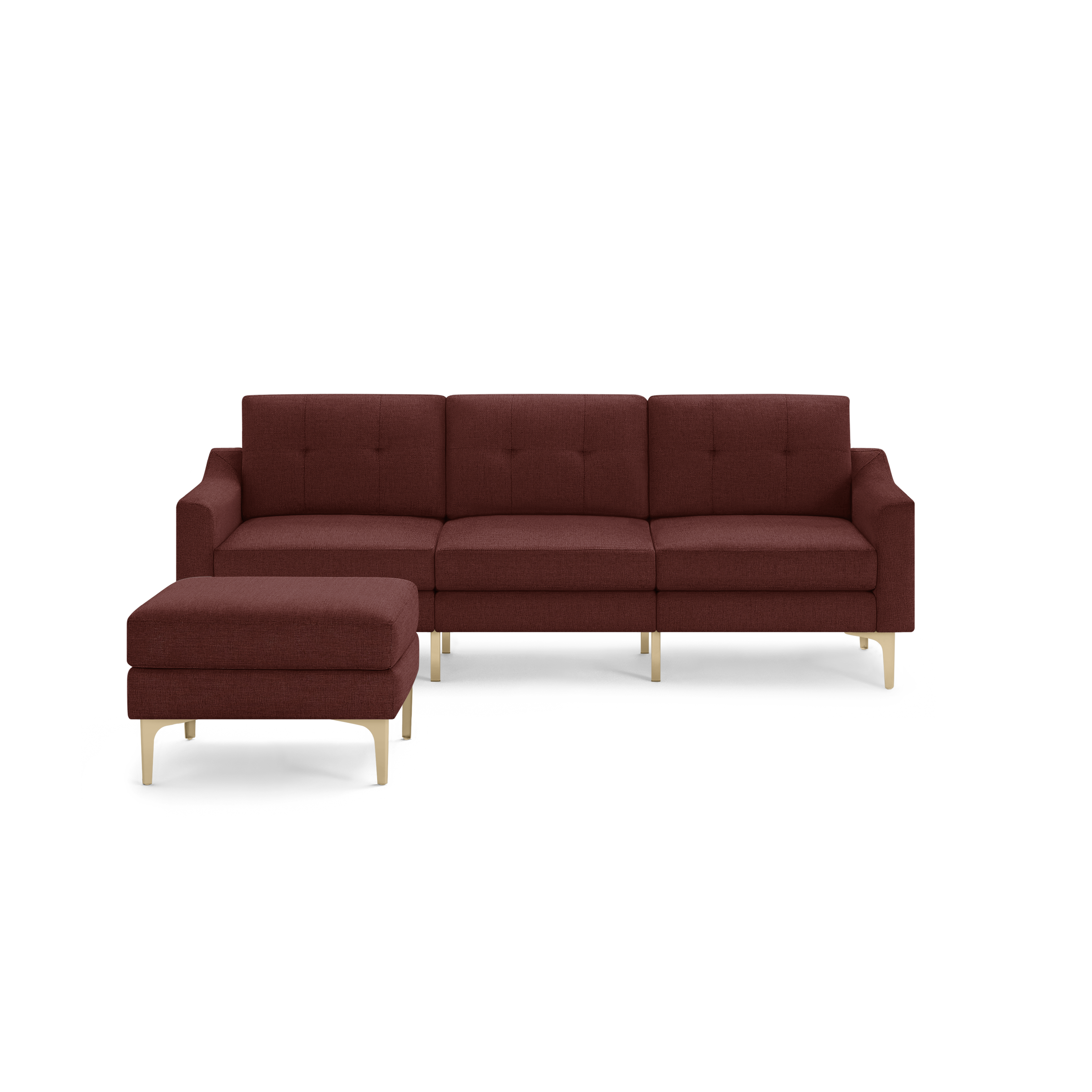 Modern sectional sofa in deep red fabric with button tufting and light wooden legs, including a matching ottoman.