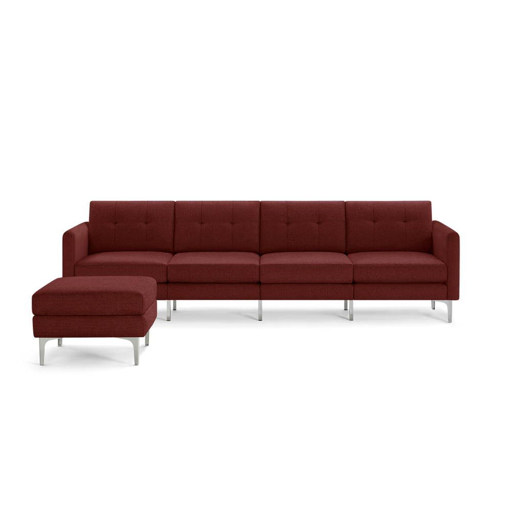 Modern sectional sofa in deep red fabric with tufted back cushions and metal legs, featuring a matching ottoman.