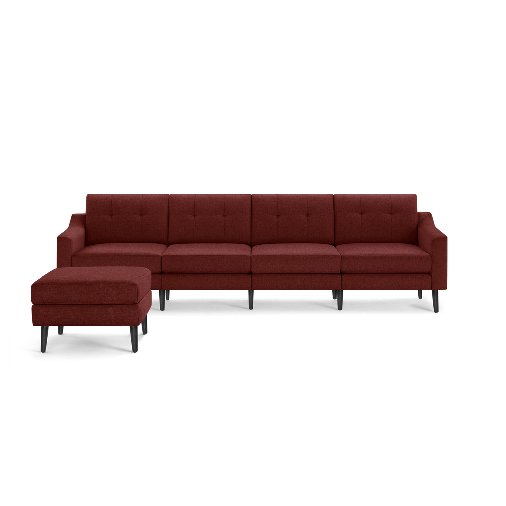 Modern sectional sofa in deep red fabric with tufted backrest, black tapered legs, and a matching ottoman on the left side.