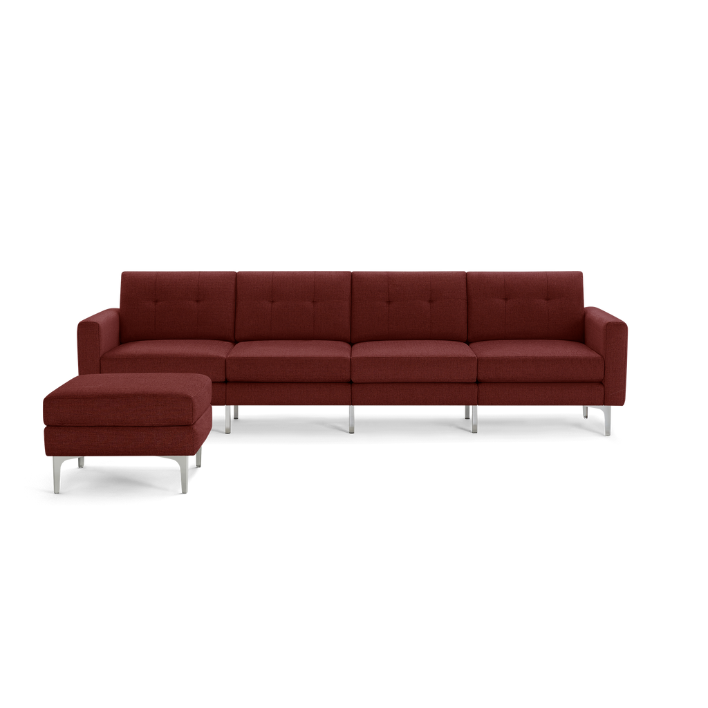 Modern deep red sectional sofa with tufted cushions, metal legs, and matching ottoman, designed for spacious living rooms.