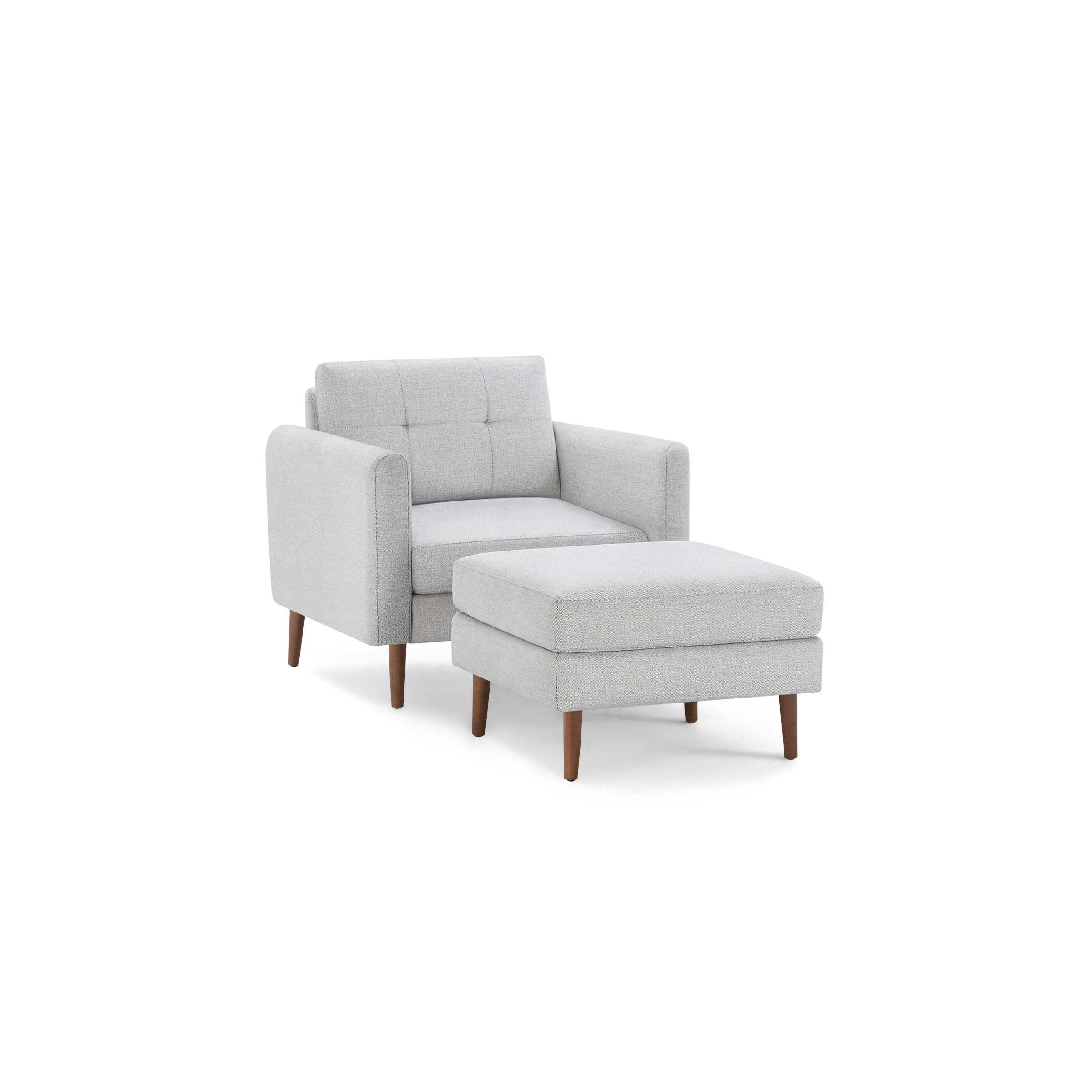 Light gray fabric armchair with tufted backrest and matching ottoman, both featuring wooden legs in mid-century modern style.